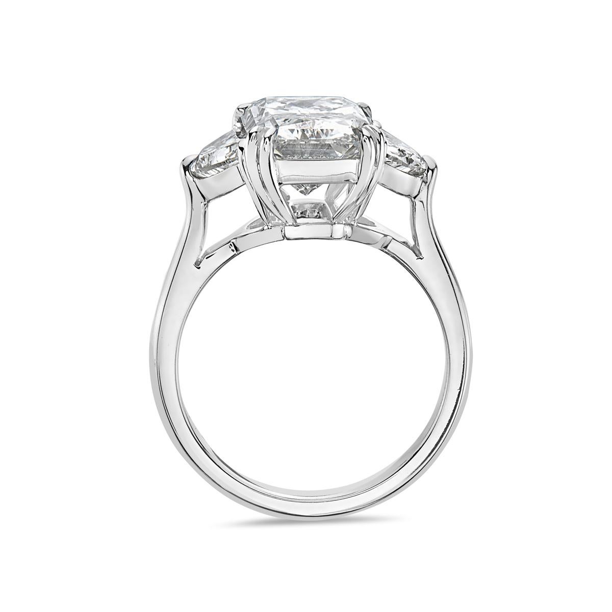 This engagement ring features a 5.01 carat rectangular radiant G VS1 cut diamond mounted in platinum flanked by two half moon G-H VVS-VS diamonds. 9.1 grams total weight. Made in USA. GIA Report No. 10048814. 

Can be resized upon request.

Viewings