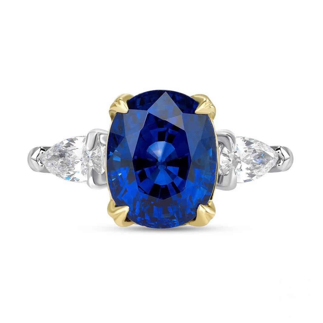 This alluring cobalt 5.01-carat Madagascar sapphire possesses a rich blue color, accompanied by an AGL report. The rare sapphire is enhanced by two pear-shaped white diamonds weighing a total of 0.38ct. Presented in platinum with 18K yellow gold.