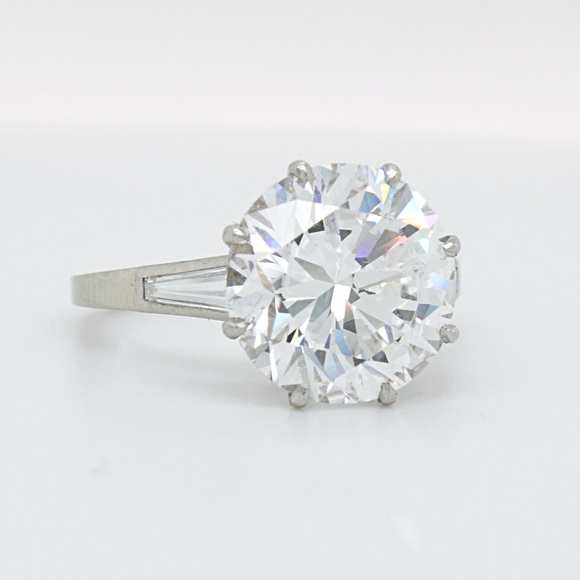 A stunning diamond round brilliant solitaire ring in white gold and platinum. The big centre stone is set in an alluring way showcasing its icy white colour from every angle - a treat of purity for the eyes. 

The centre diamond weighs 5.02 carats,