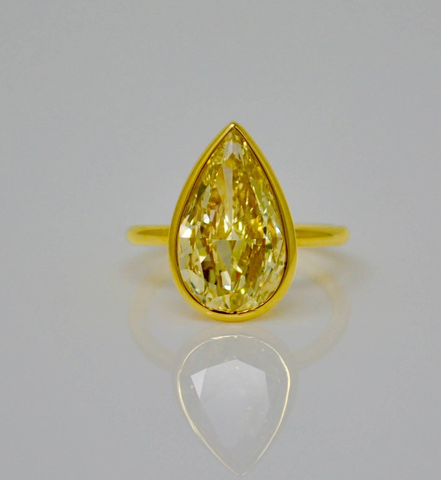 Perfect engagement ring or a special gift , this classic ring merges the best of the antique and contemporary worlds! This exquisite ring is collet set with a pear brilliant cut natural yellow diamond weighing 5.02 carat with VS1 clarity, GIA