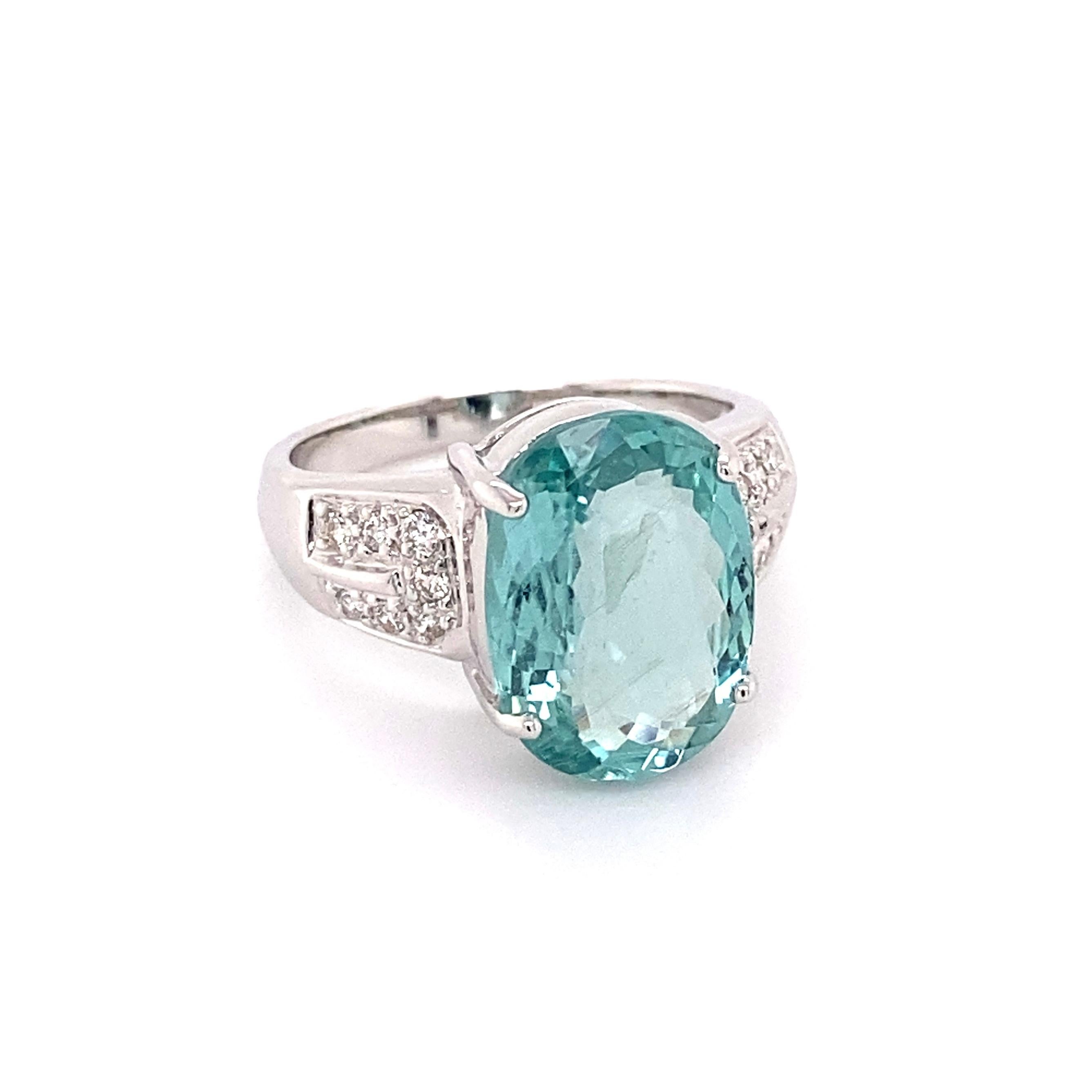Simply Beautiful! Timeless and finely detailed Paraiba Tourmaline and Diamond Cocktail Ring, center securely nestled with a Hand set 5.01 Carat Oval Blue-Green Paraiba Tourmaline, 14.03 x 10.06 x 4.88 mm and Diamonds, weighing approx. 0.18tcw