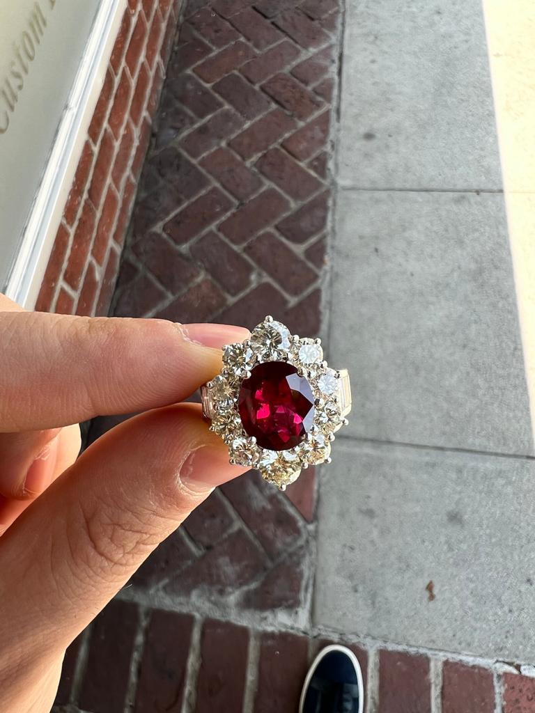 A large and fine ruby, weighing an impressive 5.03 carats, takes center stage of this platinum ring. The ruby has many characteristics which makes it fine and rare. The color is intense red while the crystal of the stone is bright and clean allowing