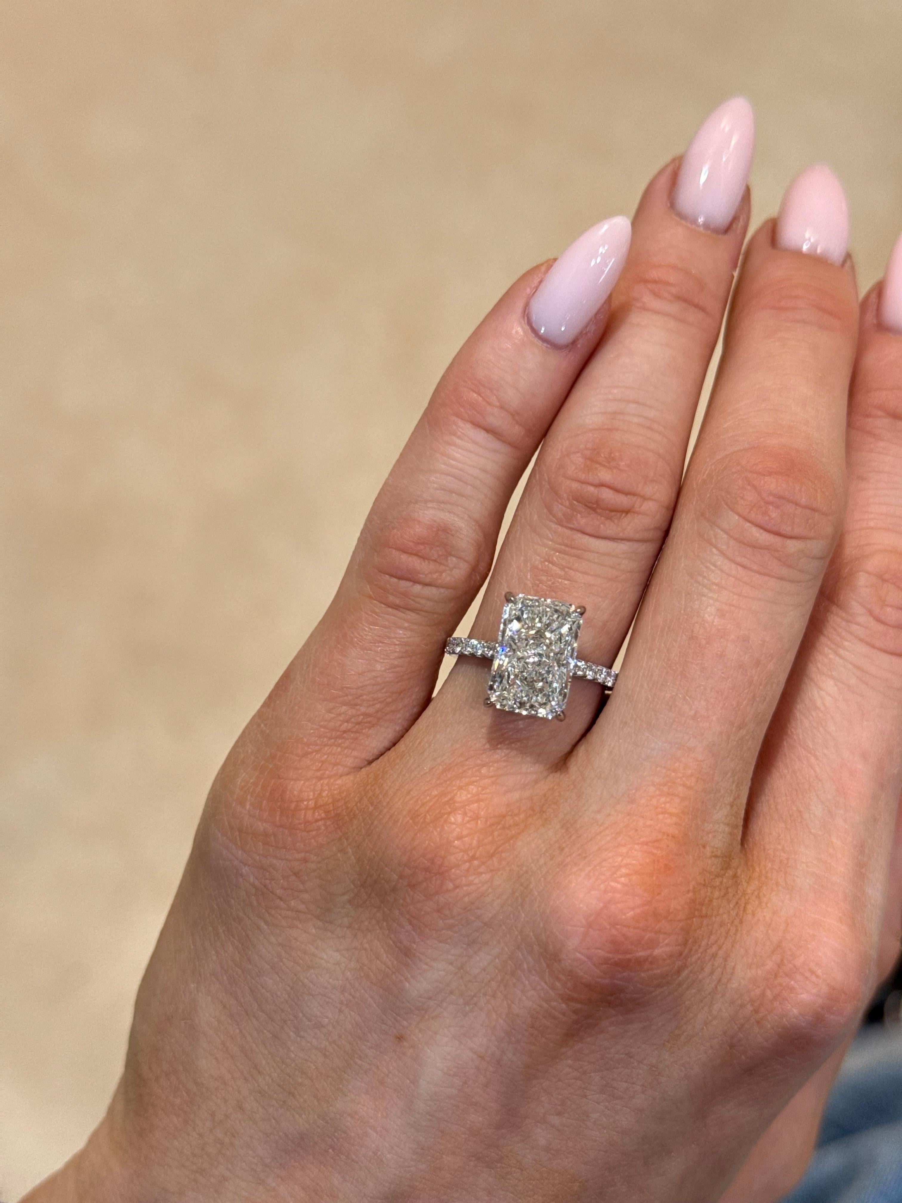 Designed to captivate, this spectacular pavé solitaire engagement ring is a true statement of refined elegance. At its heart, a GIA-certified 5.03ct radiant-cut diamond (H/SI2) radiates exceptional brilliance, set to shine from every