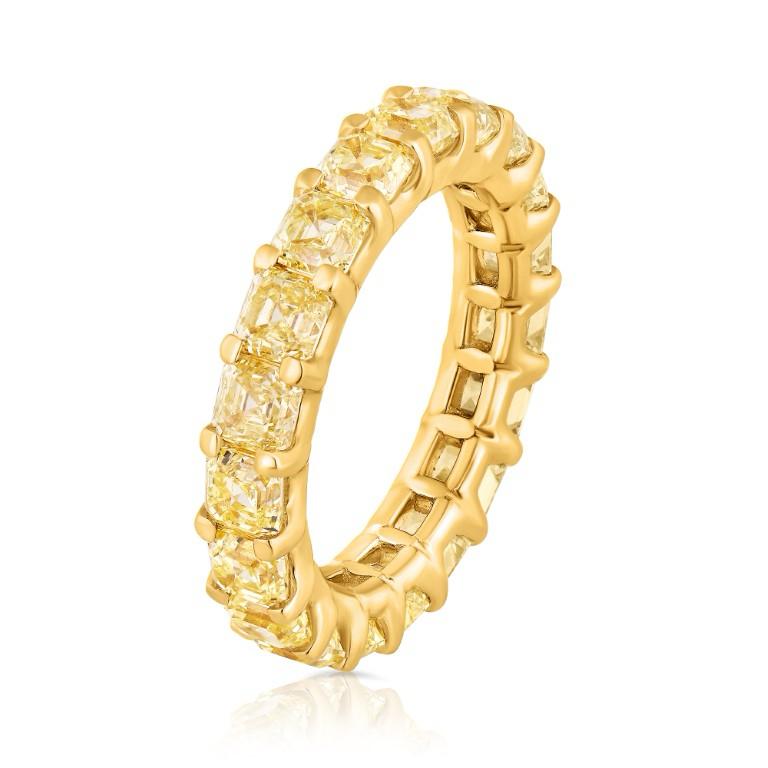 Presenting a stunning 5.04 carat Yellow Diamond Eternity band, elegantly set in a polished 18k yellow gold mounting. This exquisite piece features 21 perfectly matched yellow diamonds in both color and size. The U-Prong style enhances the allure,