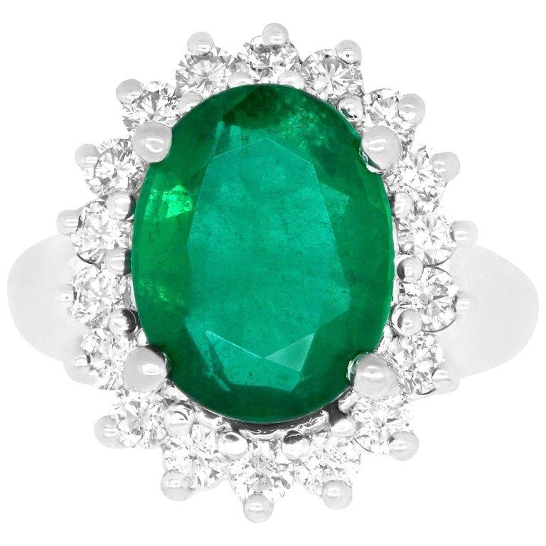 Material: 14k White Gold
Gemstones: 1 Oval Emerald at 5.04 Carats. Measuring 10 x 13 mm.
Diamonds: 18 Brilliant Round White Diamonds at 1.02 Carats. SI Clarity / H-I Color. 
Ring Size: 5.25. Alberto offers complimentary sizing on all rings.

Fine