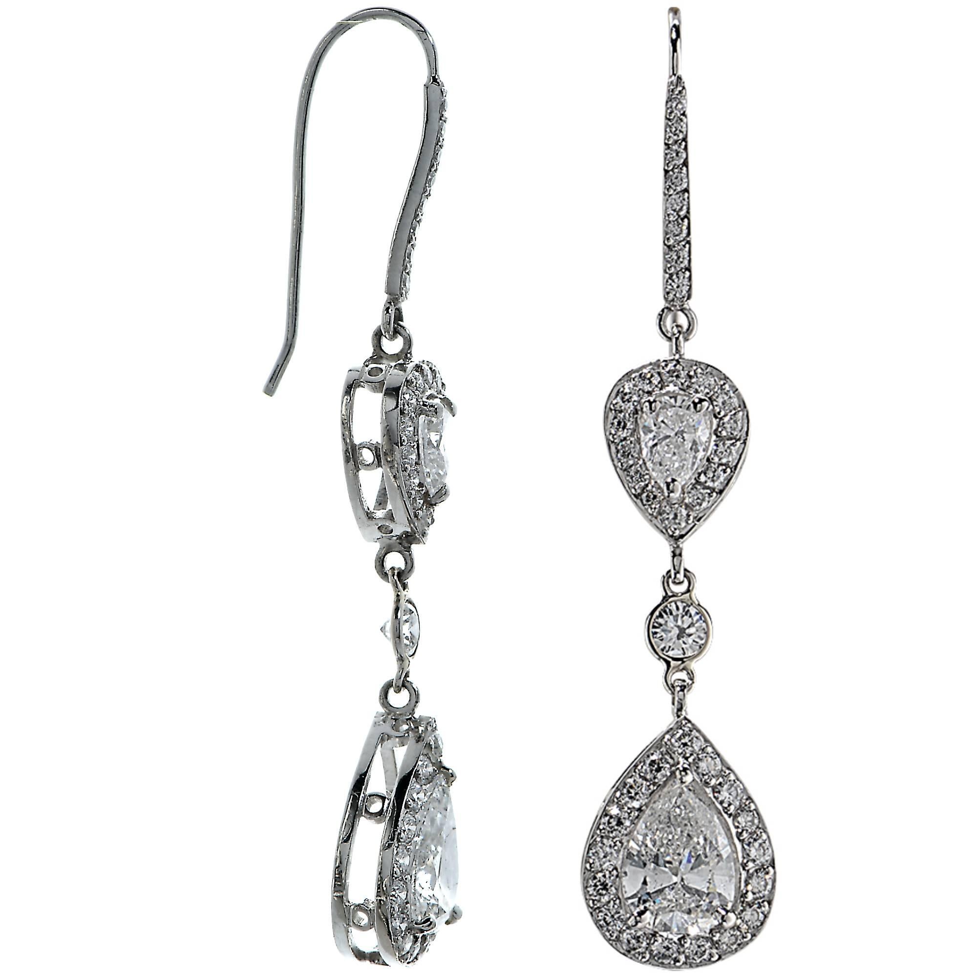 These lively platinum custom-made earrings features two pear shape diamonds weighing 3.02 carats total, E color, SI2-3 clarity and are accented by 2.03 carats of pear shape and round brilliant cut diamonds, G color, VS clarity.

Measurements are