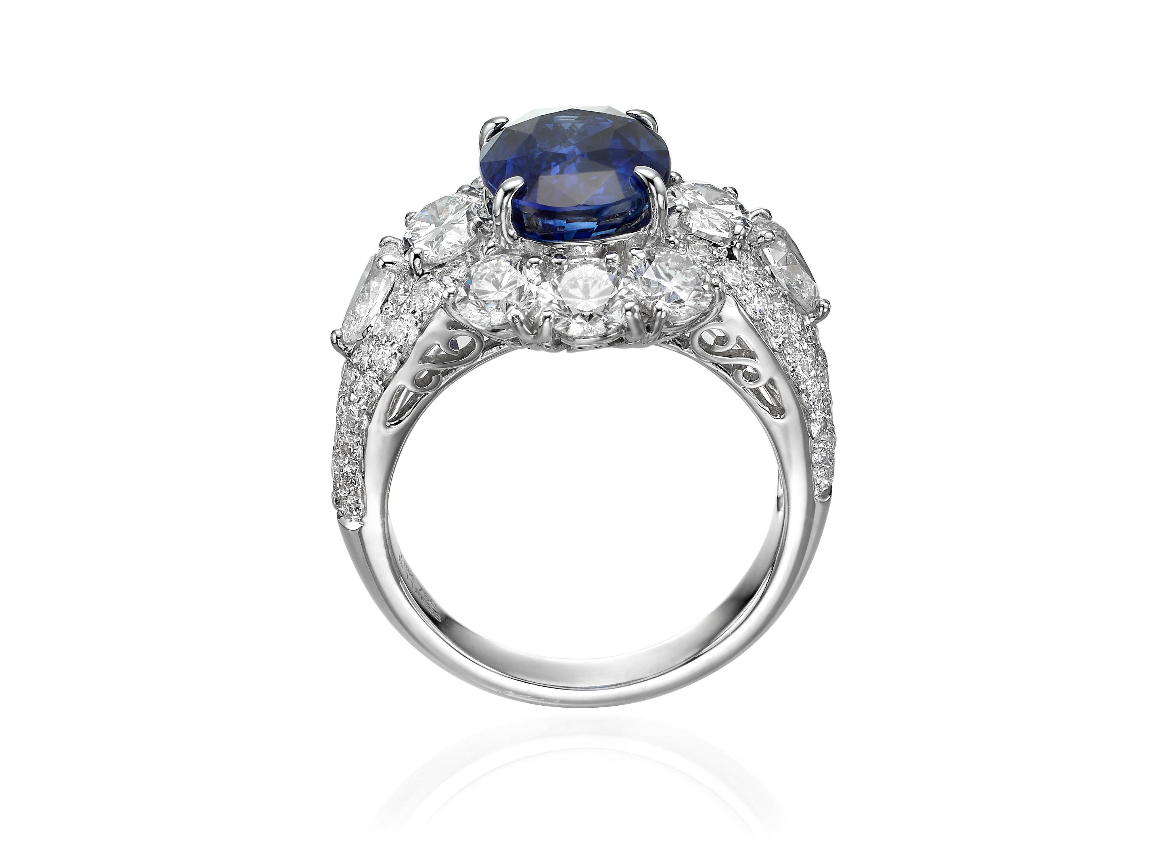 A classic royal blue sapphire diamond ring, with a 5.05 carat blue Oval Ceylon Sapphire center stone, framed by a halo of brilliant cut, oval cut, pear shape diamonds totaling 3.52 carats with a diamond pave band. Set in 18K white gold. Currently a