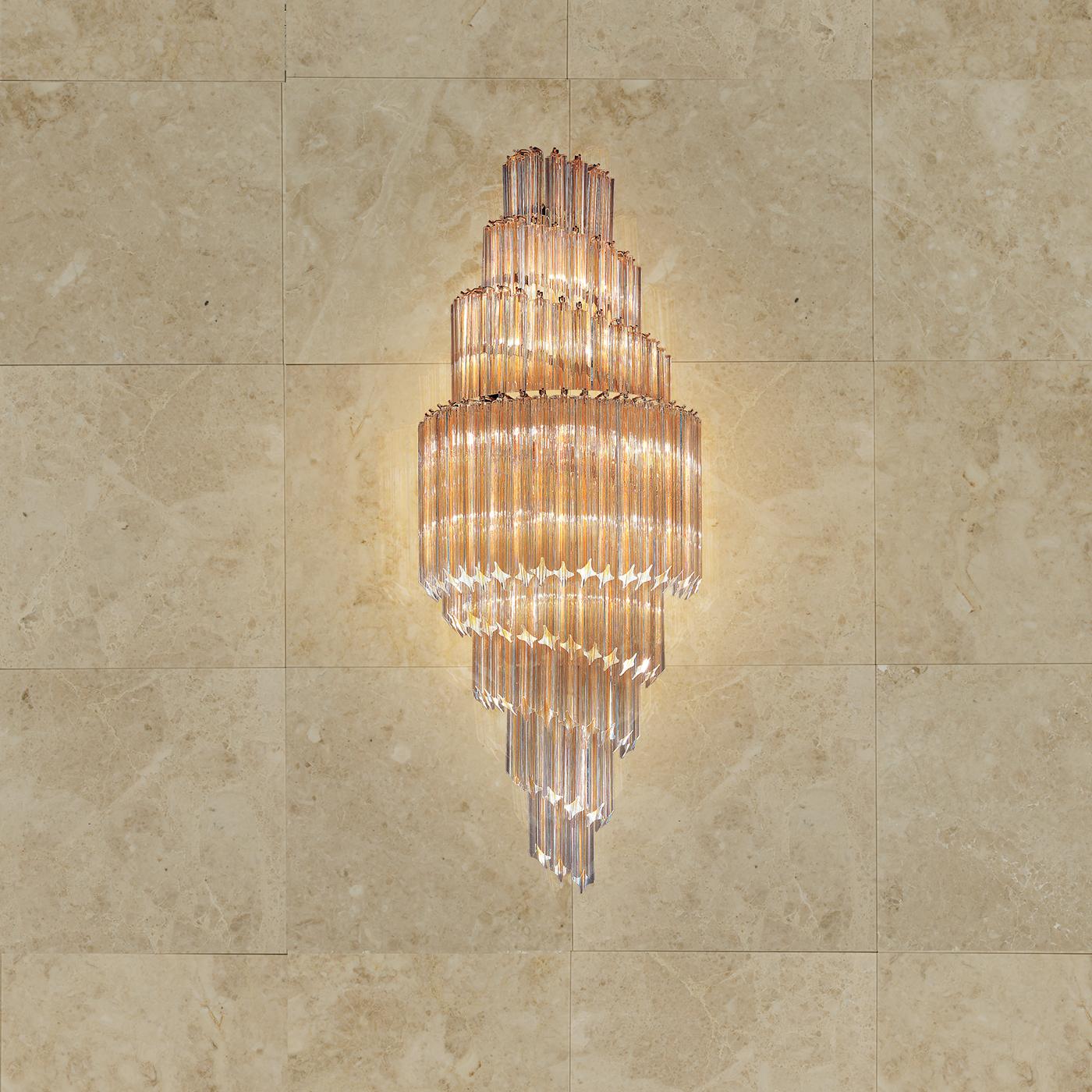 The Crystal Wall Light takes the timeless elegance of a classic chandelier and transforms it into a stylish wall light with a modern twist. Luxurious lead crystal pieces are arranged into a spiral configuration, creating a dynamic feel in any
