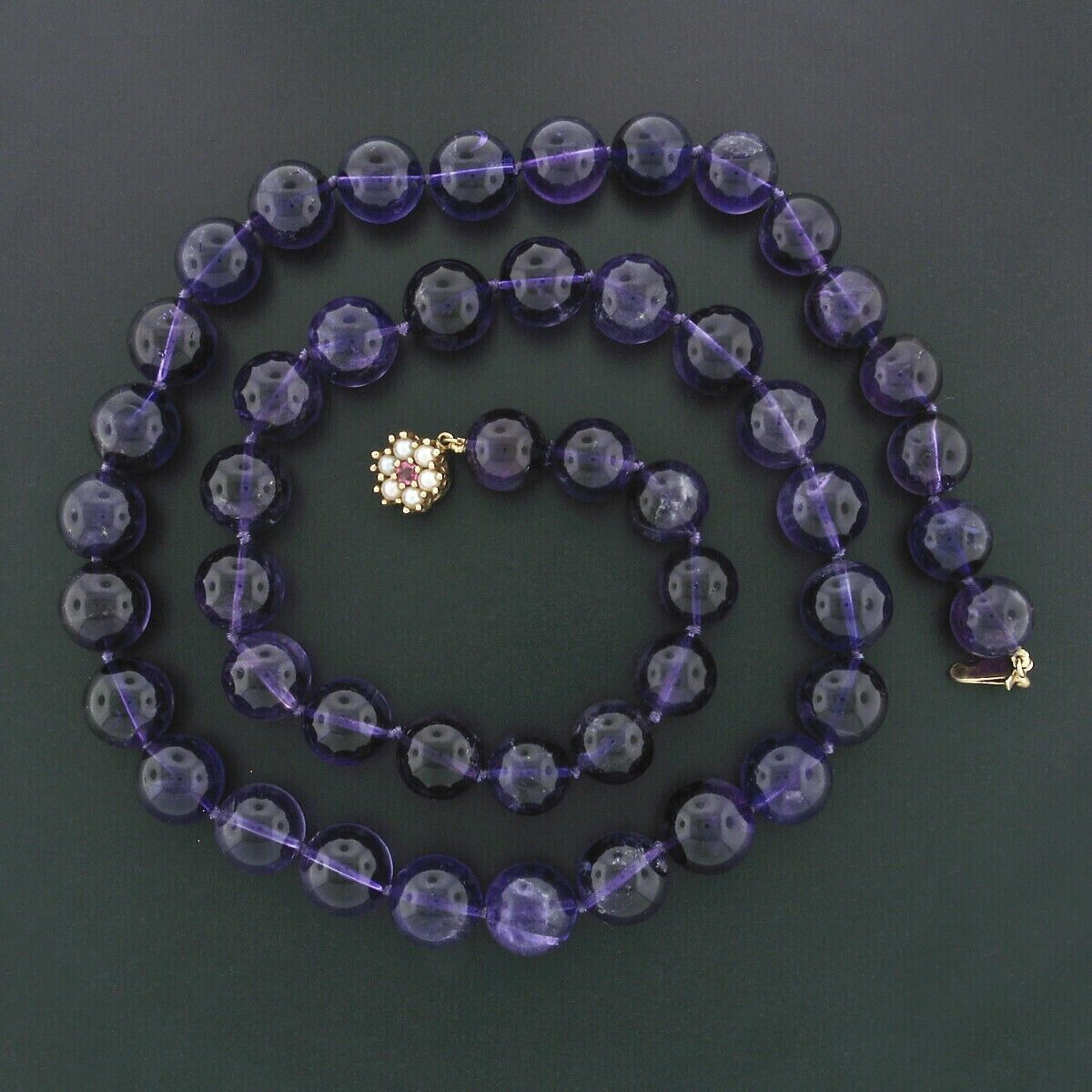 This unique and very fine vintage statement necklace features 48 round bead, genuine and natural amethyst stones. The amethysts display very desirable and naturally varying shades of medium to rich and deep purple color. They are relatively large in