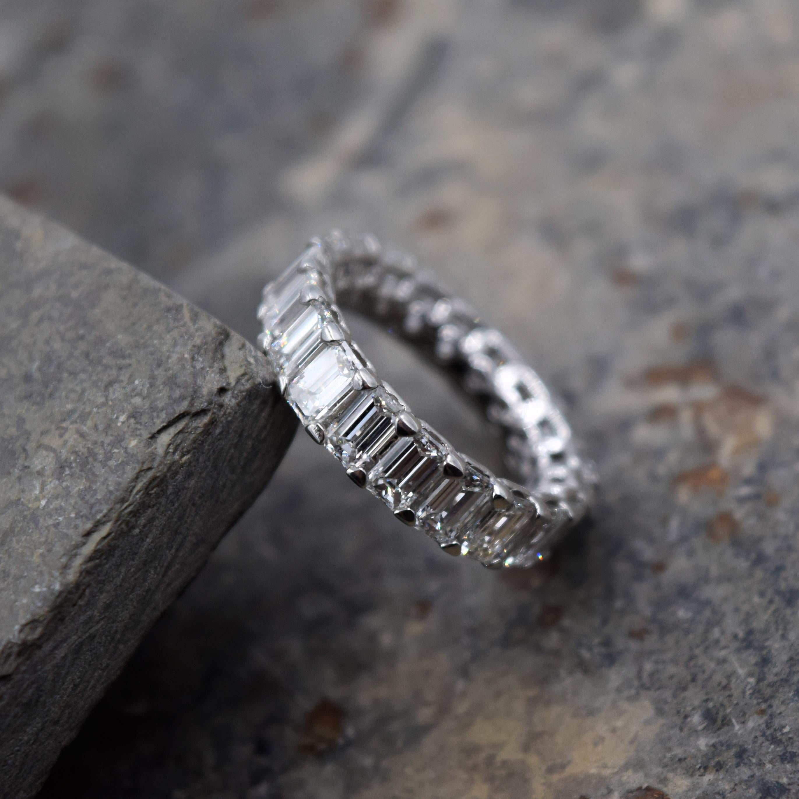 Beautiful Diamond Band by Elliott Chandler.
20 emerald cut diamonds totaling 5.06 carats are prong set in a platinum setting.
The size of this ring is 5 and can not be sized.