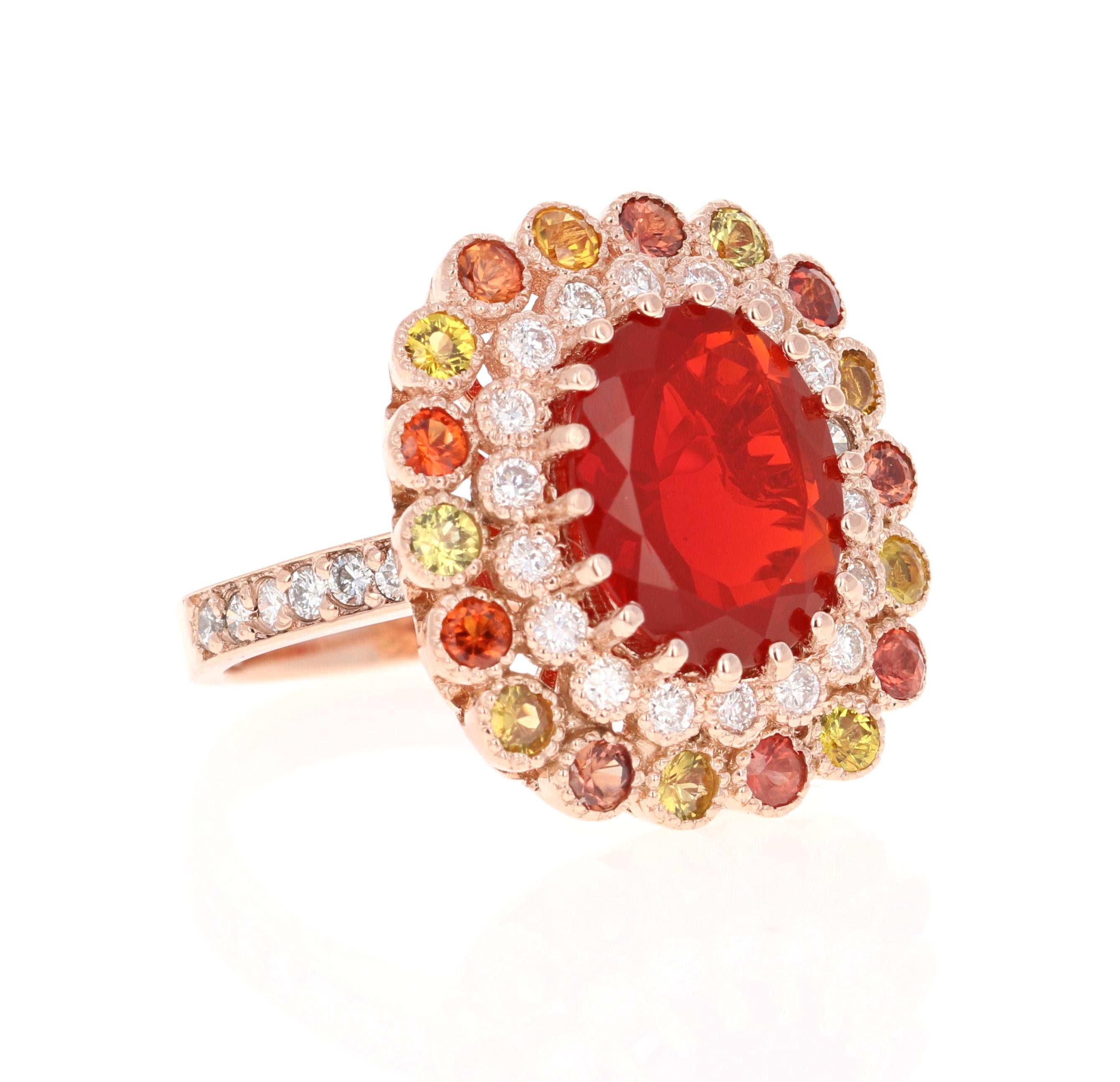 Super gorgeous and uniquely designed 5.06 Carat Fire Opal and Multi-Colored Sapphire and Diamond 14K Rose Gold Cocktail Ring!

This ring has a 2.92 carat Oval Cut Fire Opal as its center stone and is elegantly surrounded by 18 Round Cut