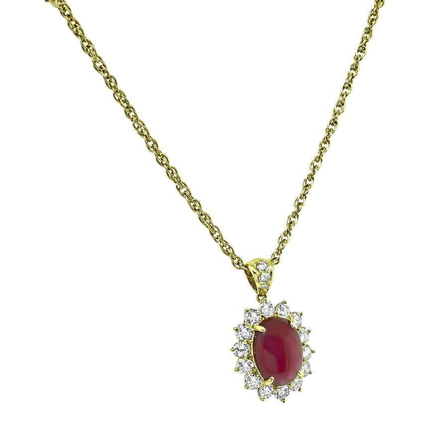 This is a charming 18k yellow gold pendant necklace. The pendant is centered with a lovely cabochon Burma ruby that weighs approximately 5.06ct. The ruby is accentuated by sparkling round cut diamonds that weigh approximately 1.40ct. The color of