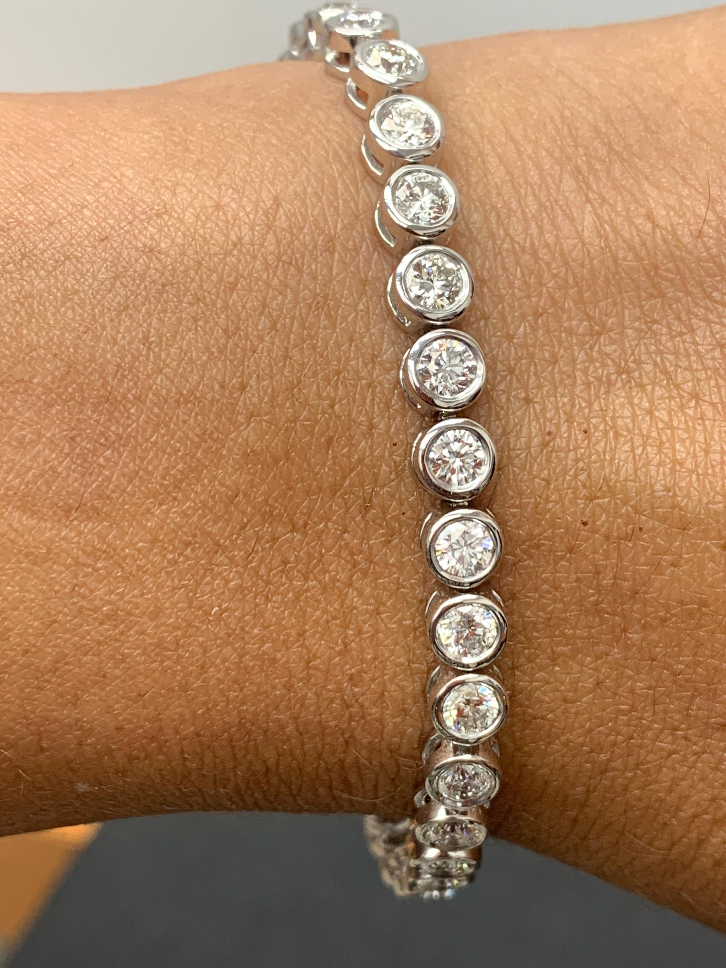 A versatile and timeless tennis bracelet showcasing a row of round brilliant diamonds weighing 5.07 carats total, set in Bezel setting in 14k white gold. 

All diamonds are GH color SI1 Clarity.
Style is available in different price ranges. Prices