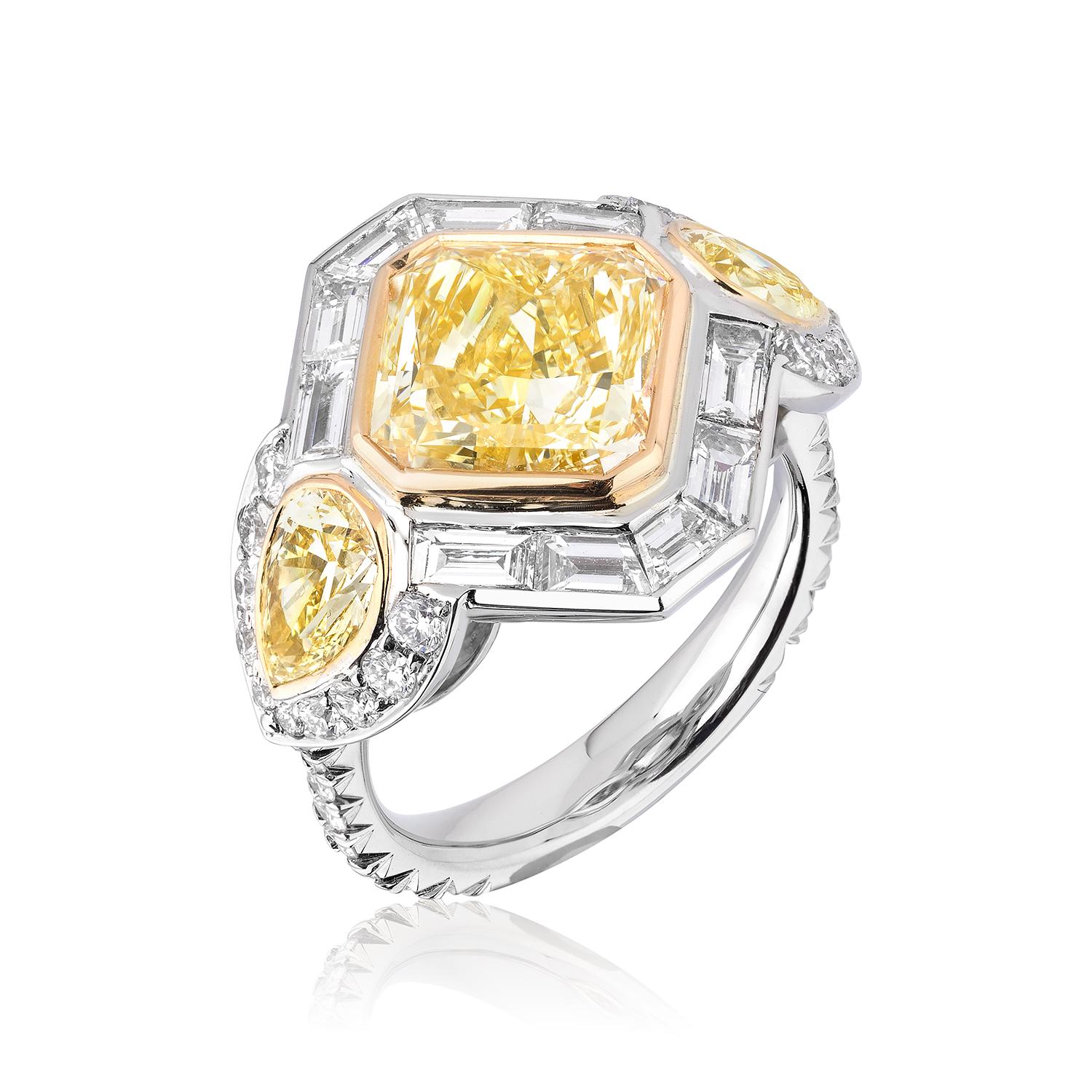 Gorgeous Yellow Diamond weighing 5.07 Carat with Yellow Pear Shaped Side Stones weighing 1.14 Carats.
White Diamond accents weigh 1.25 Carats.
Set in Platinum and 18 Karat Yellow Gold.
Size 6.
