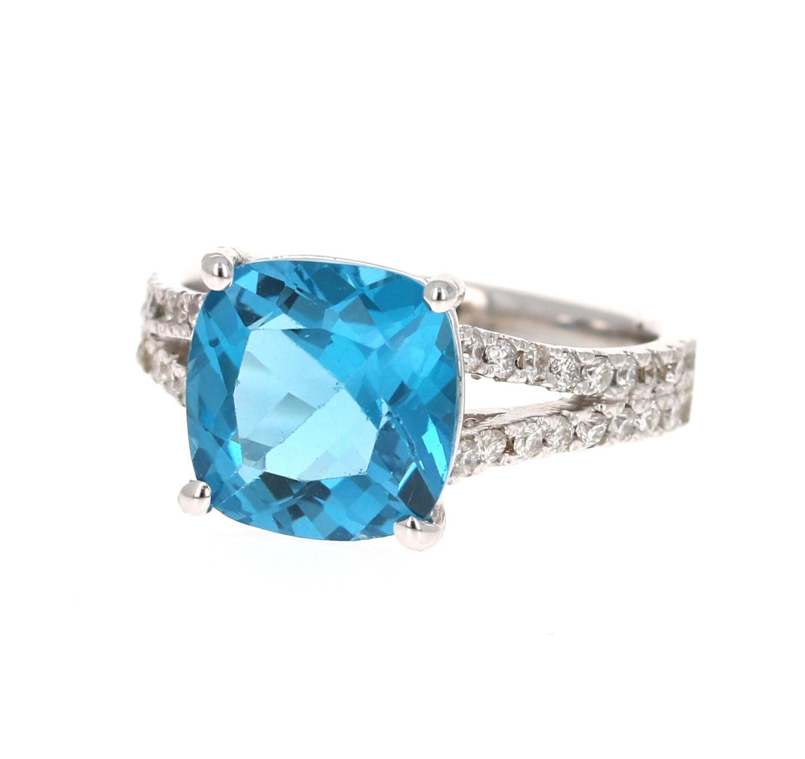 Stunning Cushion Cut Blue Topaz and Diamond ring has a gorgeous Blue Topaz that weighs 4.66 Carats. It is surrounded by 36 Round Cut Diamonds along the shank of the ring that weigh 0.42 Carats. The total carat weight of the ring is 5.08 Carats.