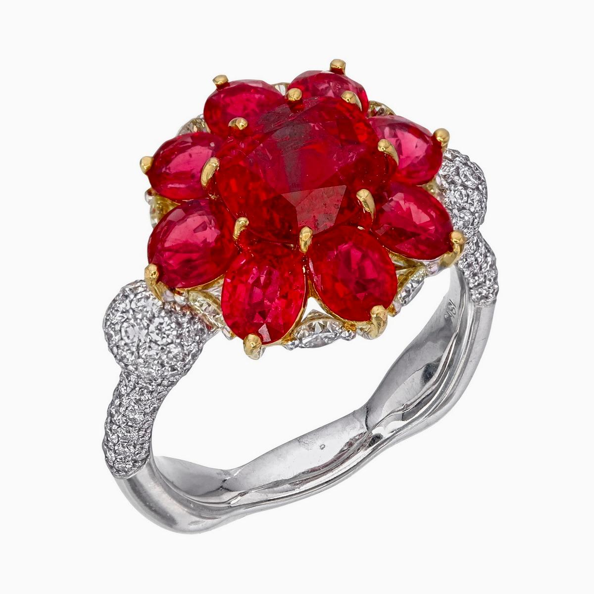 This exquisite ruby and diamond ring made by Rewa jewels in 18 karat white gold.

The vibrant centre piece is 1.98 carat weight approximately.
Surrounded by 9 pieces of rubies in 3.10 carat weight approximately. The total rubies weight is 5.08 carat