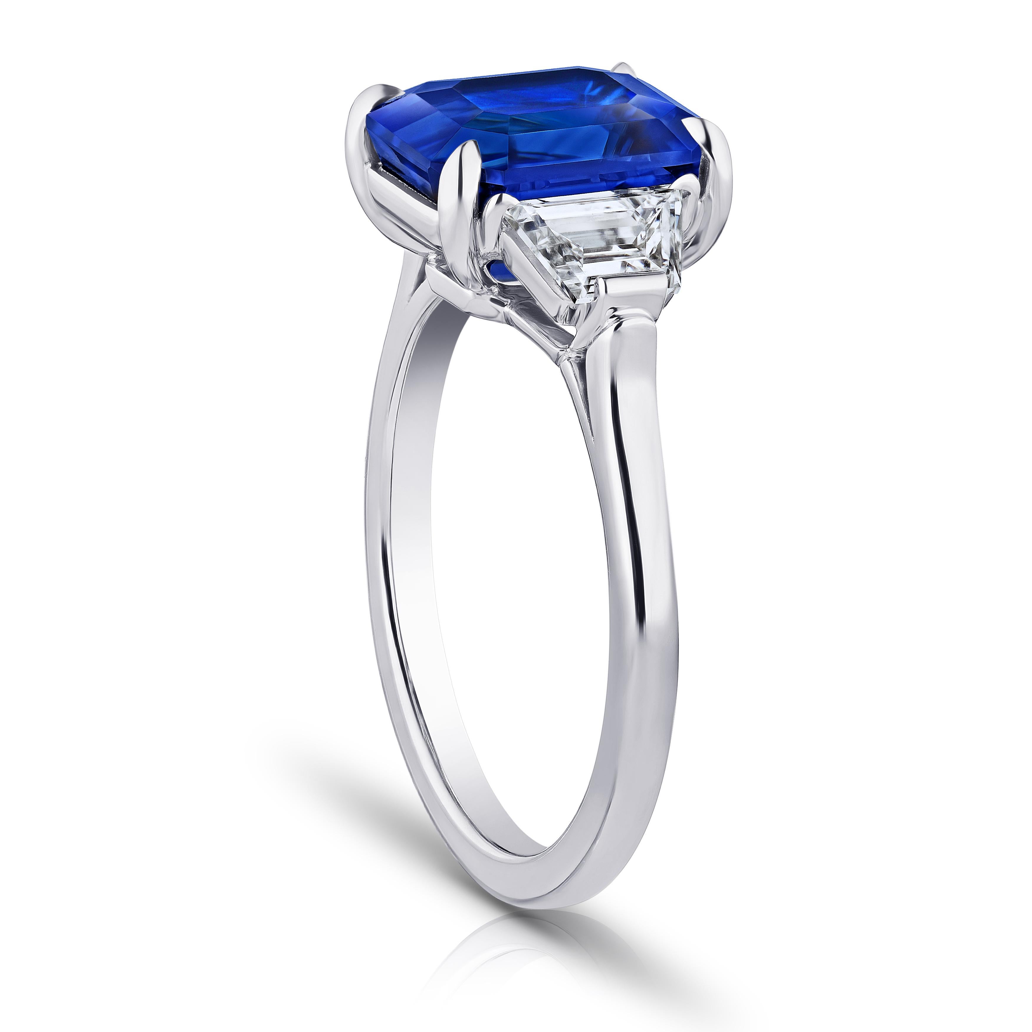 5.08 carat emerald cut blue sapphire with trapezoid diamonds .81 carats set in a platinum ring. Size 7.
