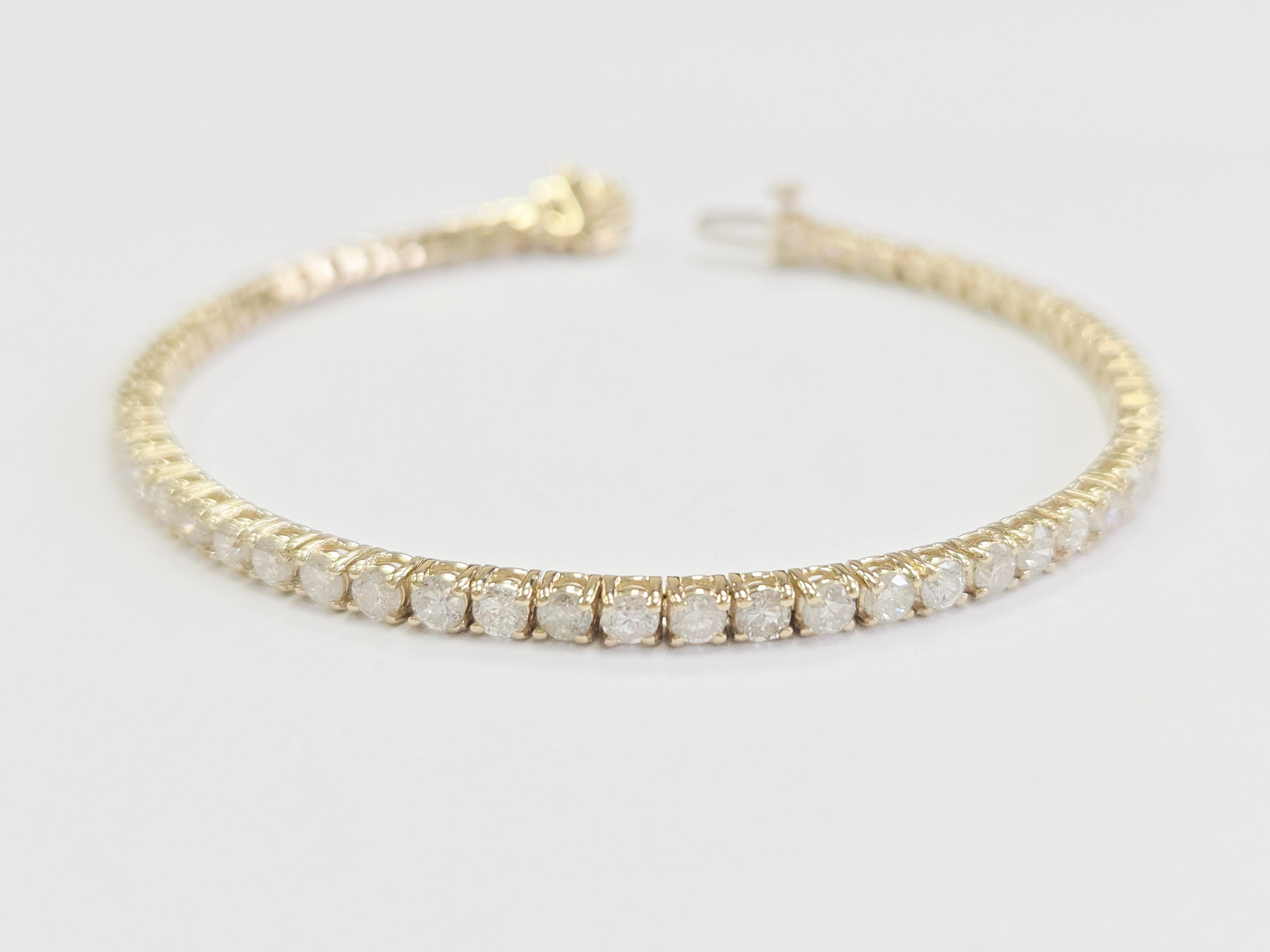 This exquisite tennis bracelet features round brilliant cut white diamonds, known for their exceptional brilliance and sparkle. Set in a classic four-prong style, the diamonds are carefully secured to maximize light reflection for an unmatched
