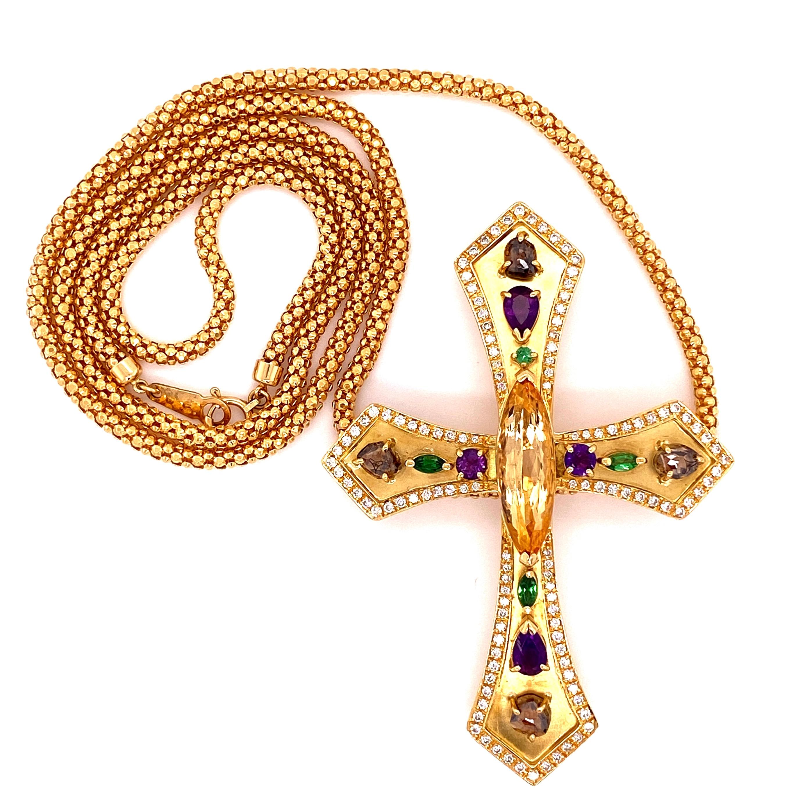 Beautiful Finely Detailed Gemstone and Diamond Gold Cross. Hand set with a 5.08 Carat Topaz in center, Gemstones and surrounded by Diamonds, approx. 0.95tcw. Hand crafted in 18K Yellow Gold. Suspended from an 18K Yellow Gold chain, approx. 24” long.