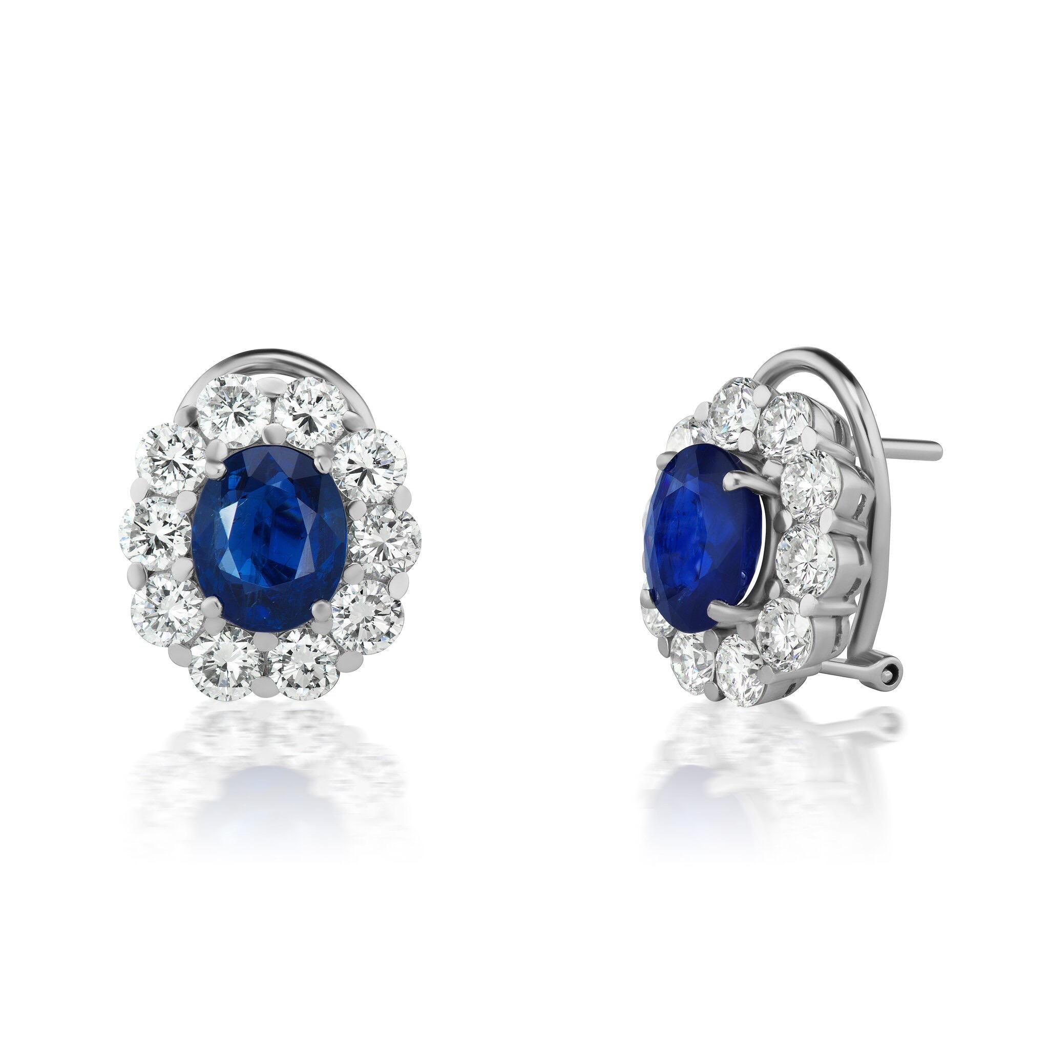 NON-HEATED BURMA SAPPHIRES and Conflict Free Diamond Cluster Earrings made for Royalty! The oval Sapphires total 5.08 total weight and the diamond halo clusters contain 20  F color VS quality diamonds weighing 4.00 CT. total weight. They are set in