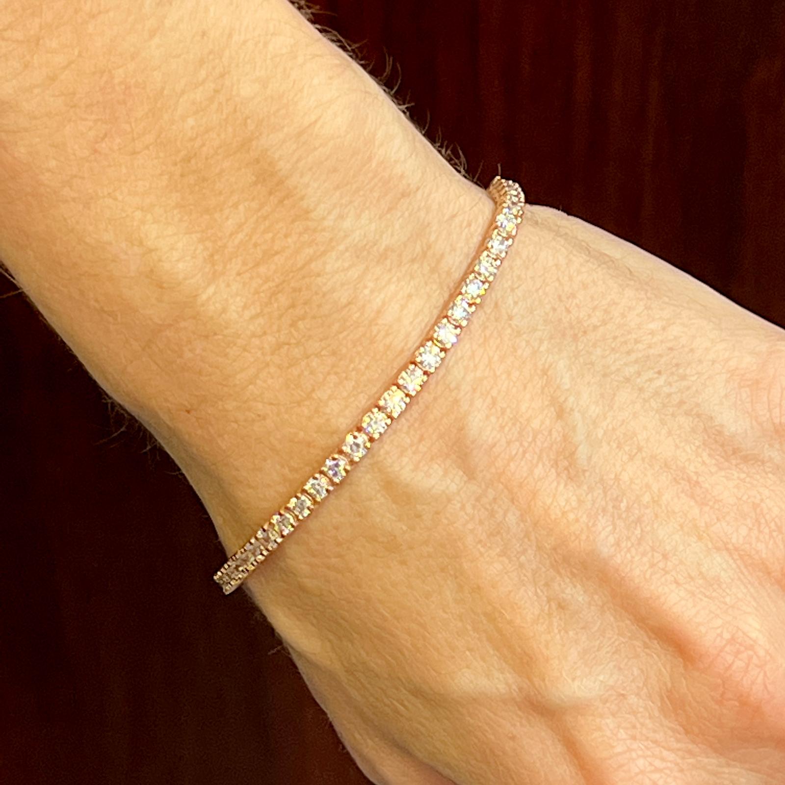 Round brilliant diamond tennis bracelet crafted in 14 karat rose gold. The bracelet features 51 round brilliant cut diamonds weighing 5.08 carat total weight. The vibrant diamonds are graded G-H color and SI clartity. The bracelet measures 7.0