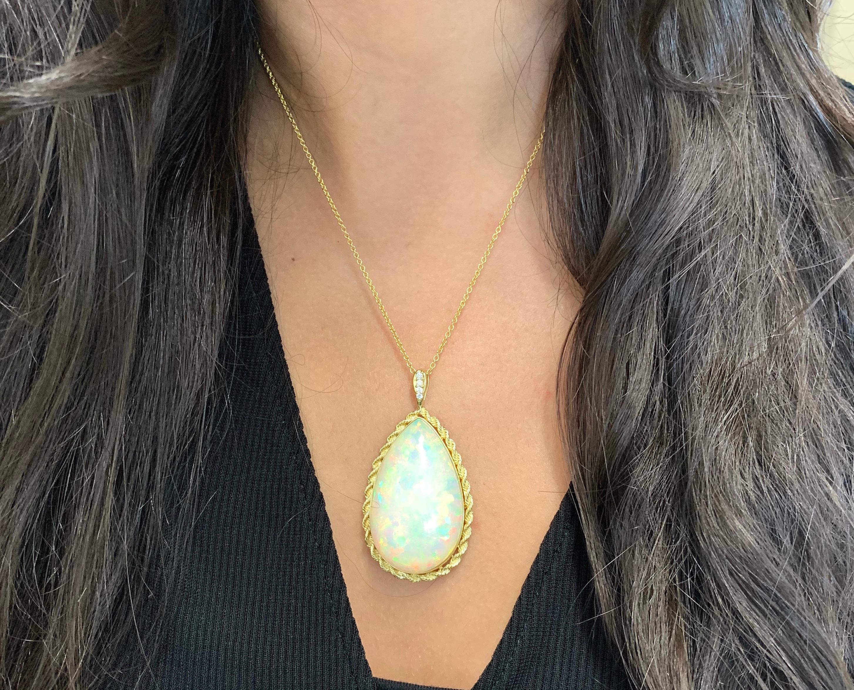 Material: 18K Yellow Gold 
Center Stone Details: 50.80 Carat Pear Shaped Opal - 40 x 25 mm
Diamonds: 4 Round Diamonds at 0.10 Carats.  SI Quality /  H-I Color

Fine one-of-a-kind craftsmanship meets incredible quality in this breathtaking piece of