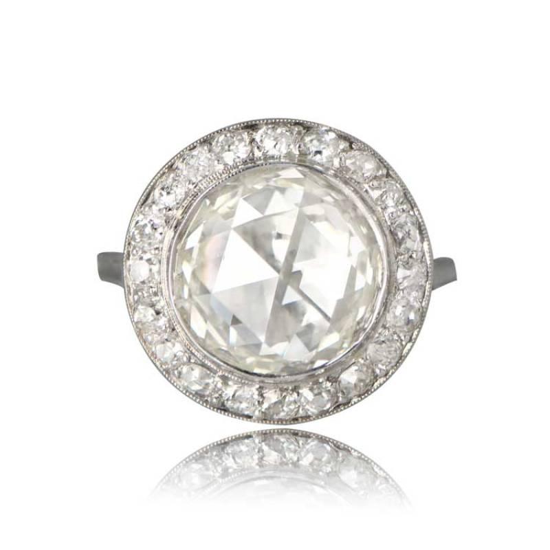 An exquisite rose-cut ring featuring an antique round rose-cut diamond at the center, weighing around 5.08 carats with M color and VS2 clarity. The center diamond is beautifully encircled by a halo of old mine-cut diamonds. Crafted in platinum, this
