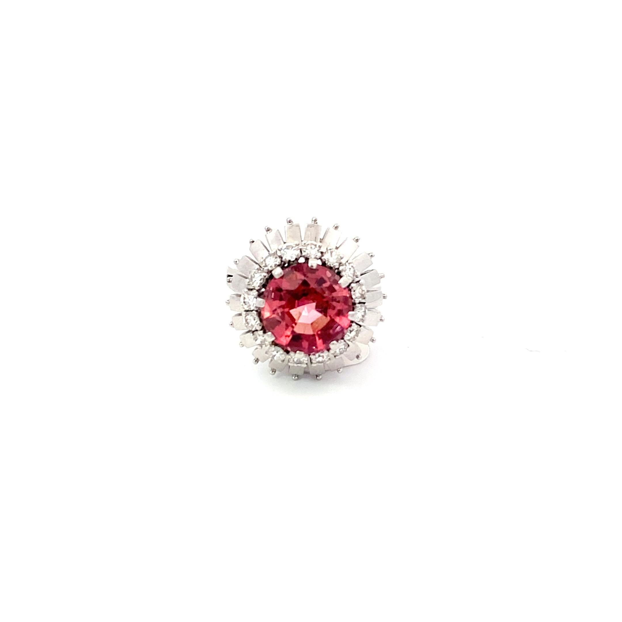 This ring from the 1960s has a very mid-century modern feel, featuring a halo of 0.9ct of Diamonds, a second halo of structural and shiny 18k White Gold surrounding a gorgeous 5.08ct Natural Pink Tourmaline (graded F VS2). The center Tourmaline has