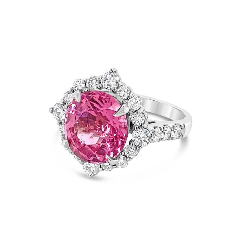 A 5.08 carat oval cut natural pink spinel surrounded by a halo of 1.03ct total weight in round brilliant cut diamonds set in 18 karat white gold. This ring is currently a size 6 but can be resized upon request.
Measurements: 10.78 x 10.15 x 6.67