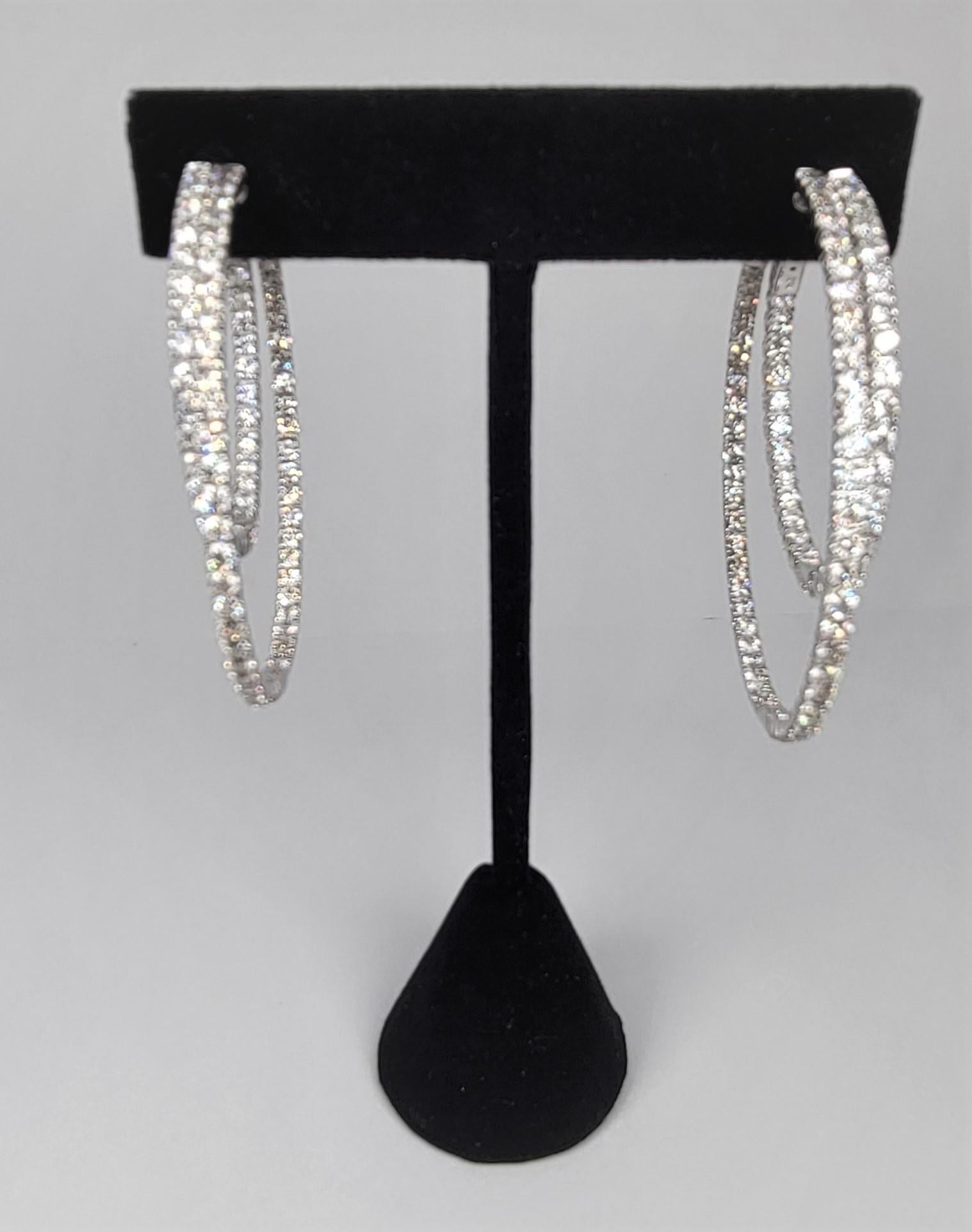 Dazzle everyone with these double in and out hoop earrings with 5.09 carats of diamonds set in 14 karat white gold.