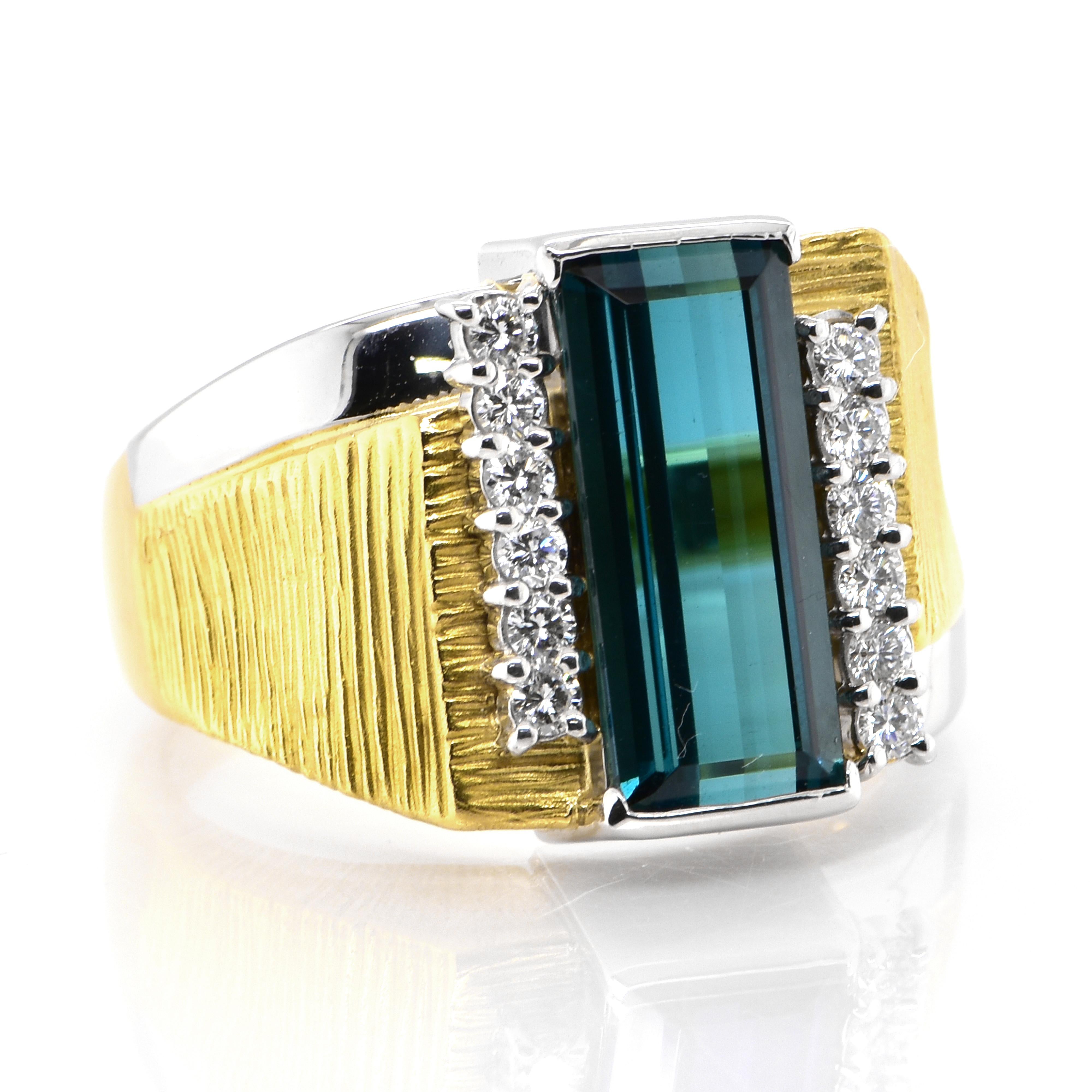 A stunning Cocktail Ring featuring a 5.09 Carat, Natural Indicolite Tourmaline and 0.35 Carats of Diamond Accents set in 18 Karat Yellow Gold and Platinum. Tourmalines were first discovered by Spanish conquistadors in Brazil in 1500s. The name