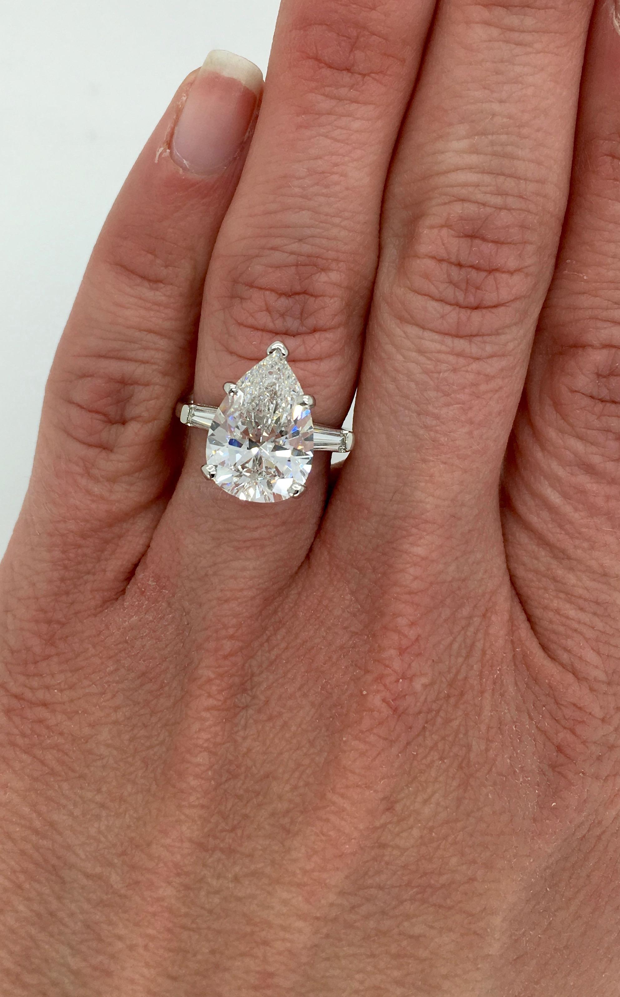 GIA certified 4.83CT Pear Cut Diamond ring with classic flanking Tapered Baguette Cut Diamonds.

GIA Certified #5192993300
Center Diamond Carat Weight: Approximately 4.83CT
Center Diamond Cut: Pear Cut
Center Diamond Color: F
Center Diamond Clarity: