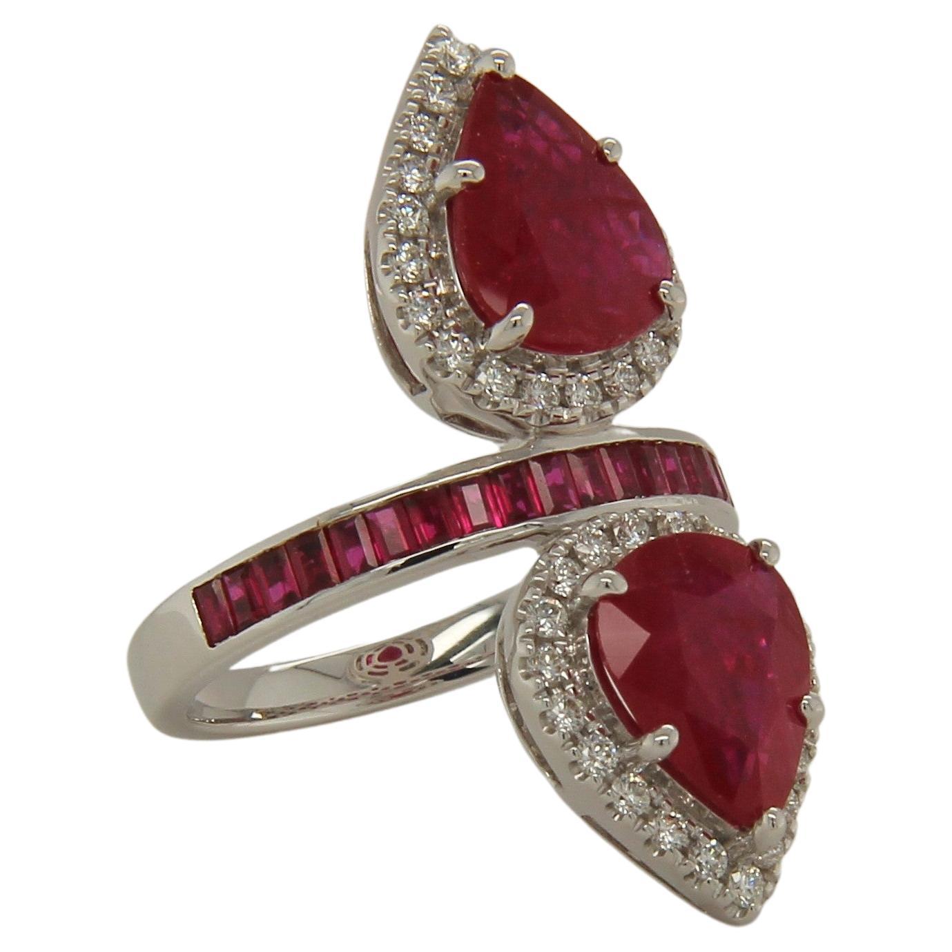 This exclusive ruby and diamond ring was made with the finest quality materials, to ensure that it is both elegant and durable. This beautiful stone set in 18K white gold showcases with two pear cut natural untreated ruby of the finest quality. Set