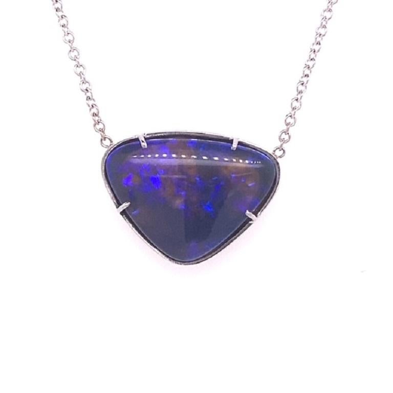 This beautiful pendant features a natural 5.09ctw natural black opal set in 18 karat white gold on an 18