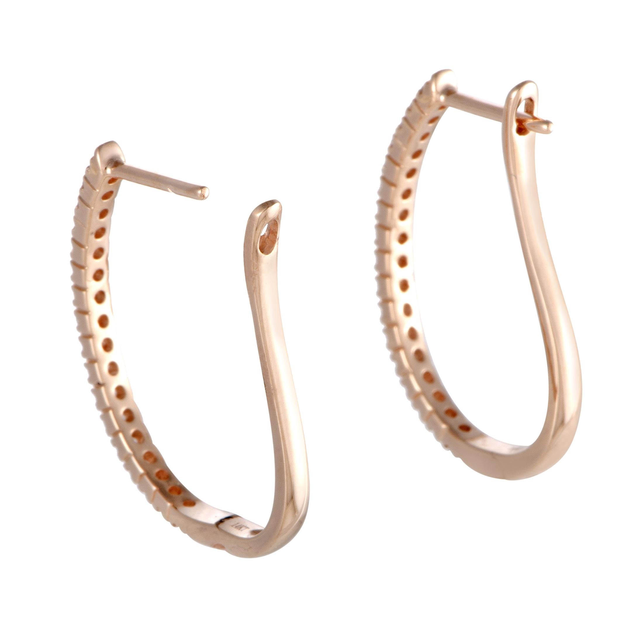The ever-alluring 14K rose gold and the luxuriously glistening diamond stones create a delightful aesthetic effect in these graceful earrings. The pair weighs 2.9 grams and is set with a total of 0.50 carats of diamonds.
