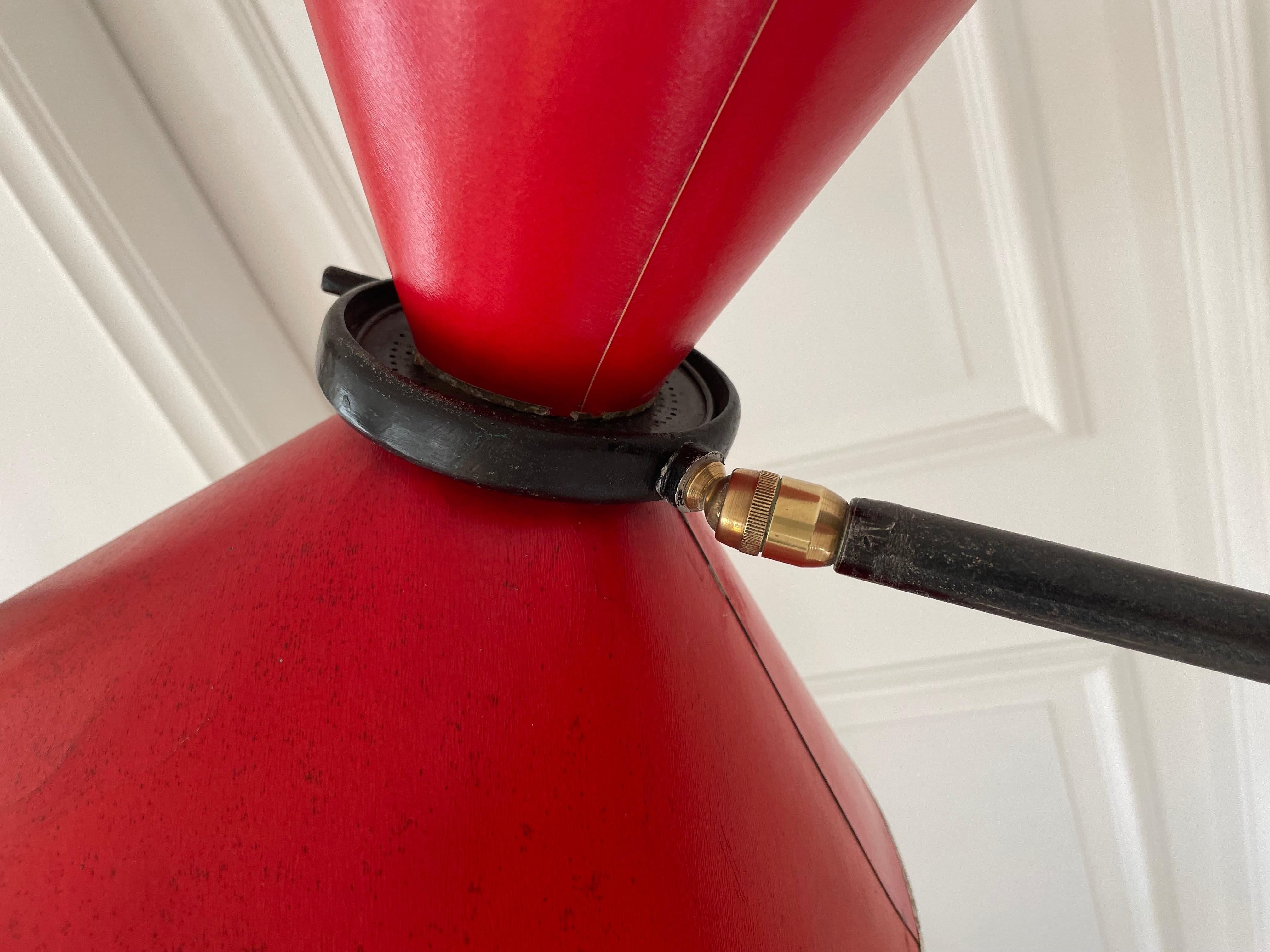 Adjustable blackened wrought iron floor lamp with his original red diabolo shade.
Brass ball joint, 2 lights and newly rewired.
By Maison Lunel- France 1954.