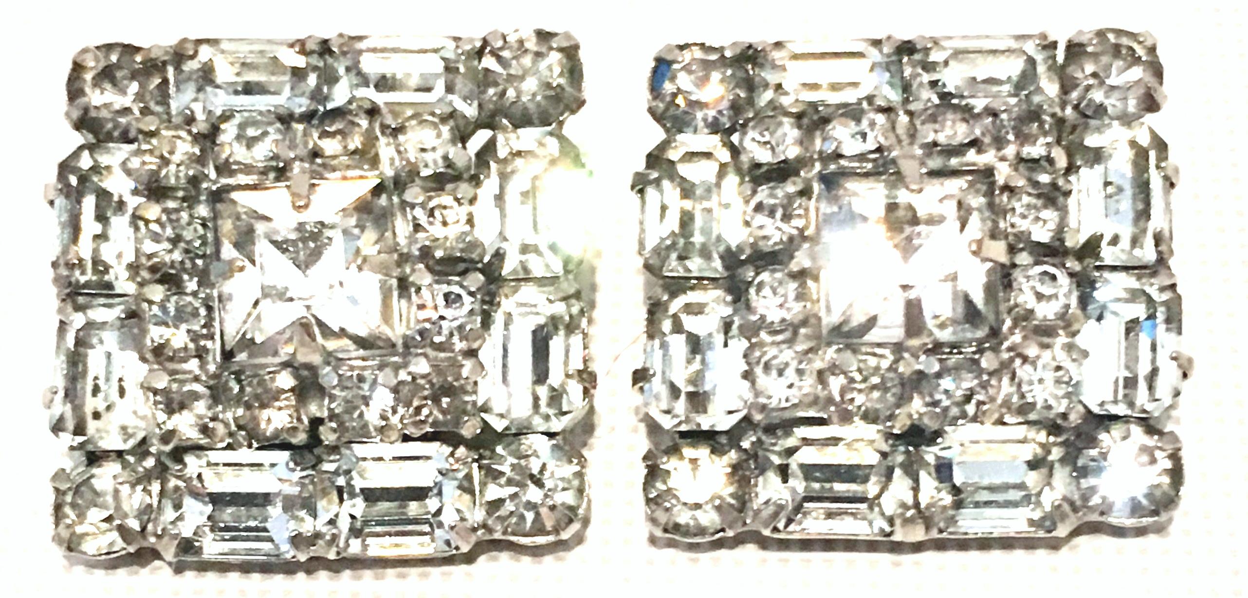 Mid-Century Art Deco Silver Pot Metal Prong Set Austrian Crystal Clear Rhinestone earrings. These brilliant and dimensional  clip style earrings feature brilliant cut and faceted baguette and round crystal rhinestones with a central square cut