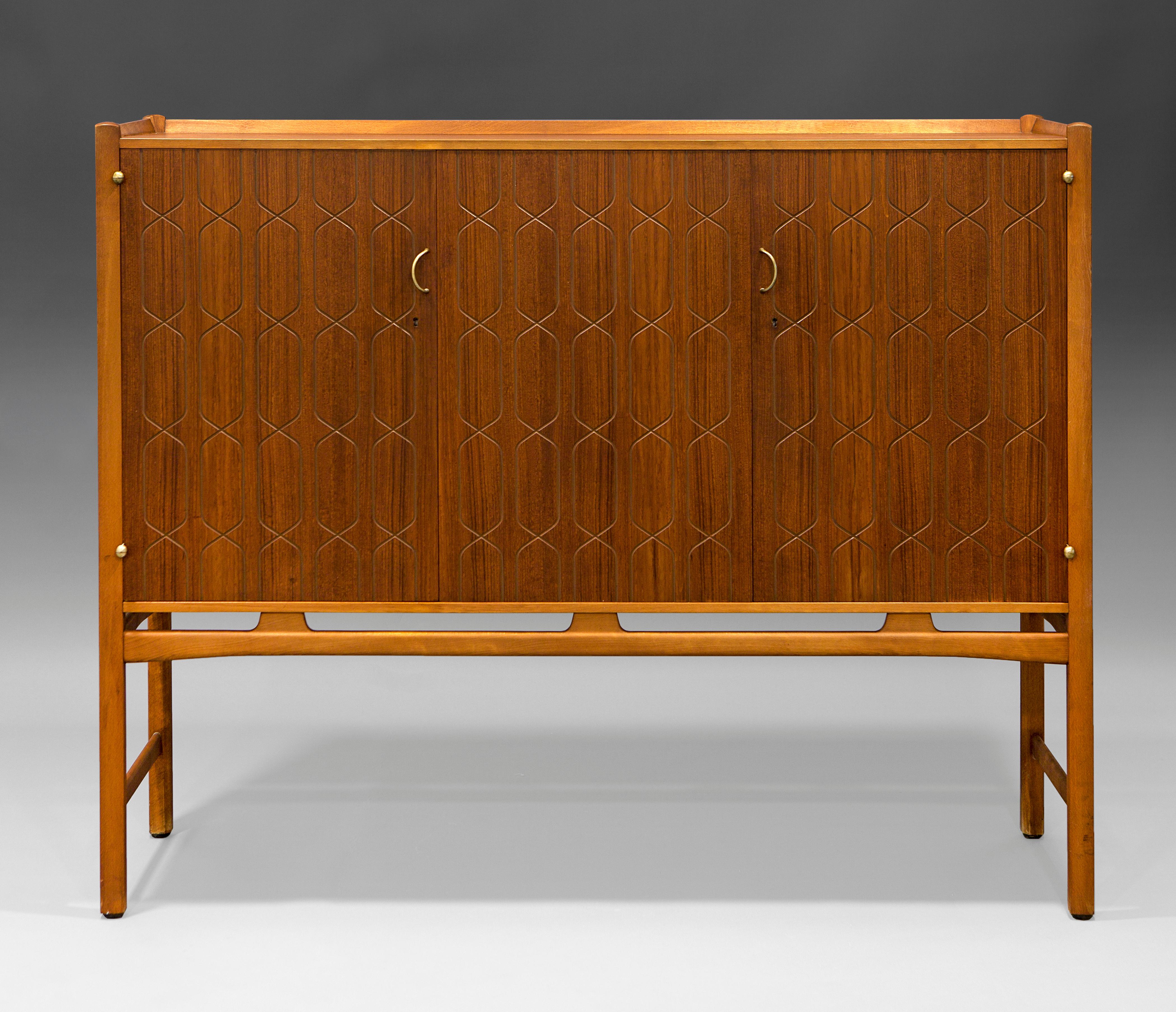 “Napoli” cabinet in teak and beech designed by David Rosén. Produced by Nordiska Kompaniet in Sweden, 50´s. This storage piece is made out of teak and beech with brass fittings. It comes with the original locks and key. The doors are carved with