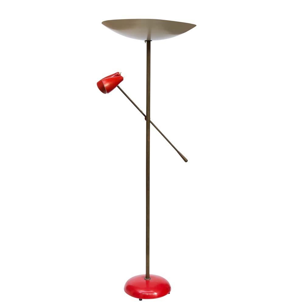 A rare floor lamp designed by Stilnovo in 1949 and produced through out the 1950s. Patinated brass structure with two articulating lamp shades and arm. Original cream enamelled metal top shade with two red shades at the end of the movable arm. The