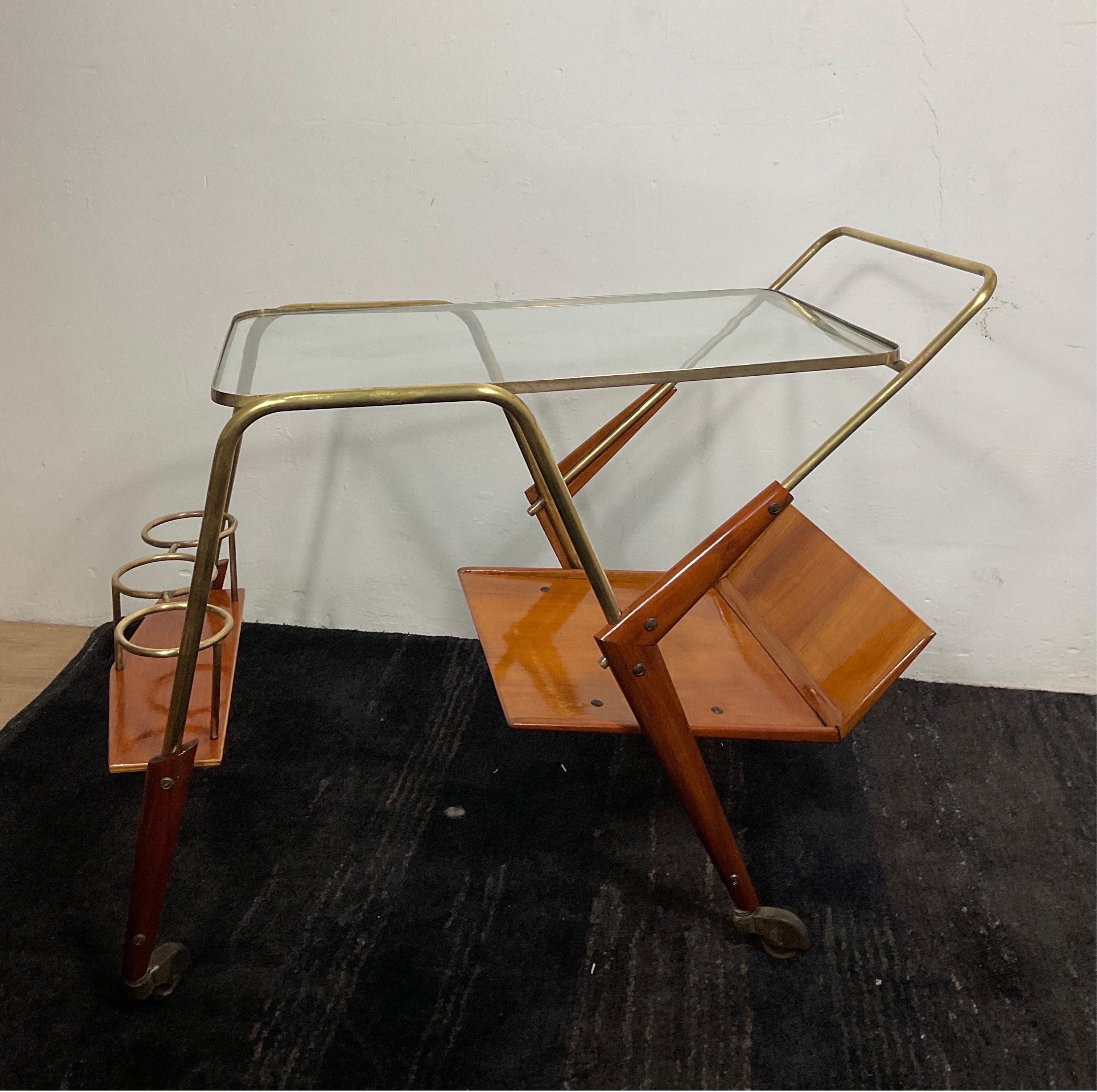 50s food trolly attributable to Cesare Lacca. Wooden trolly with brass frame and a glass surface. Cesare LACCA is an artist born in Italy in 1929. His works have been auctioned 317 times, mainly in the Furniture category. The first award recorded on