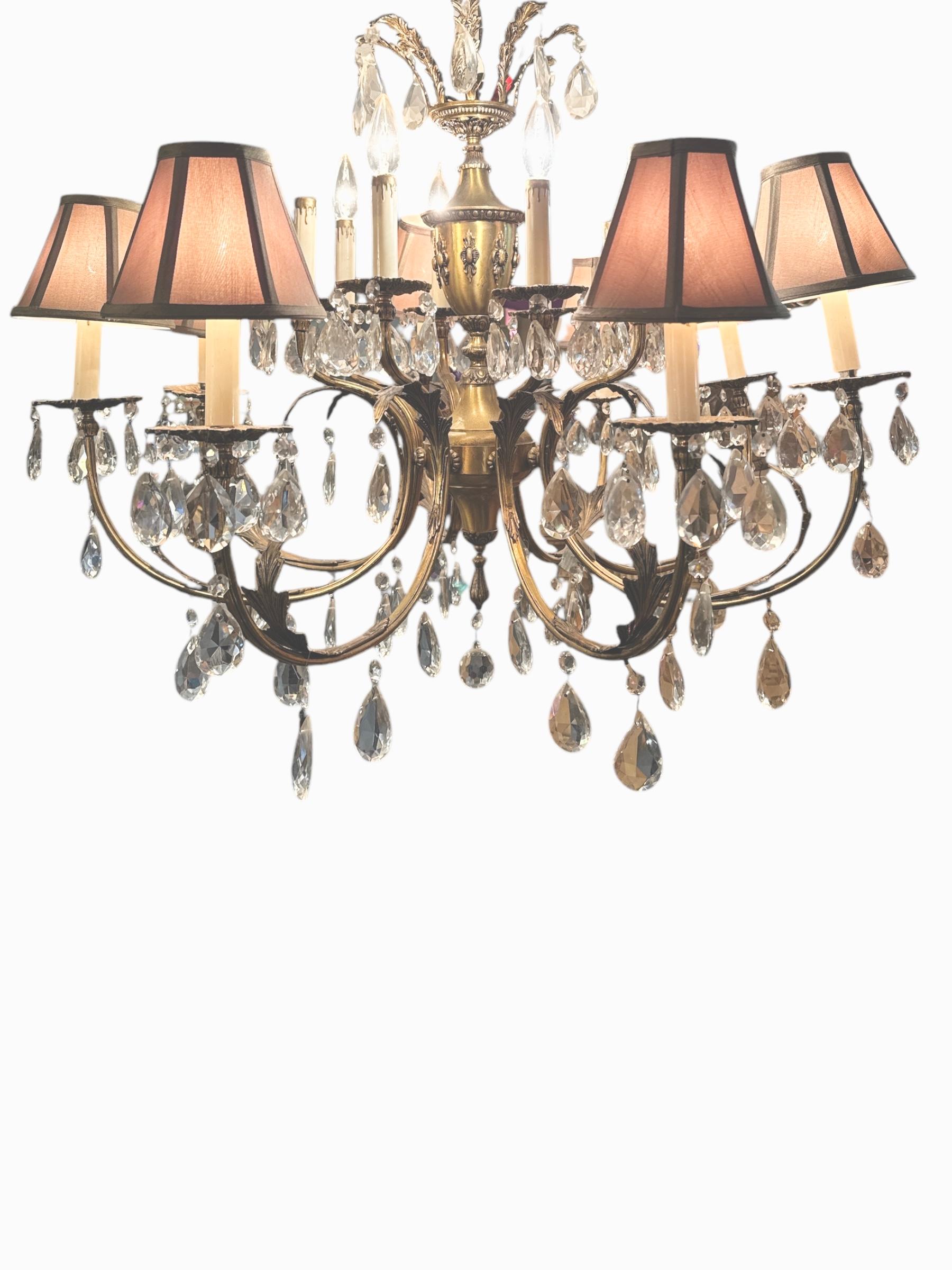 Add a touch of vintage elegance to any room with this 1950s French 16-Light Brass Crystal Cut Chandelier. A true masterpiece, this chandelier combines the grandeur of French design with timeless sophistication. The intricate brass frame exudes