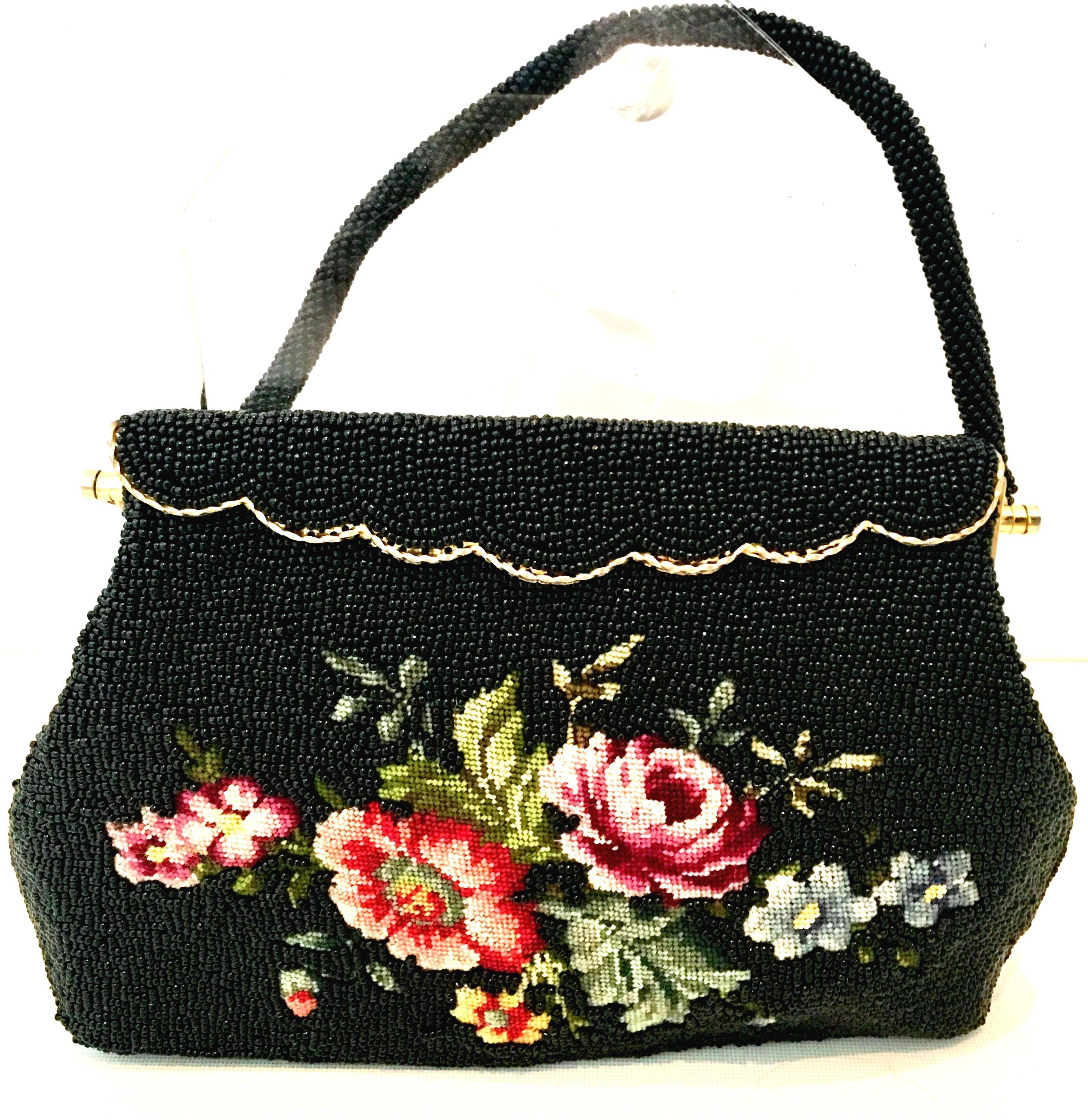 1950'S Hand Beaded & Crewel Embroidered Hong Kong Evening Bag. This pristine and unique piece is executed with jet black art glass beads, and and a crewel embroidered central floral motif. The rope style handle strap is also made of jet black art