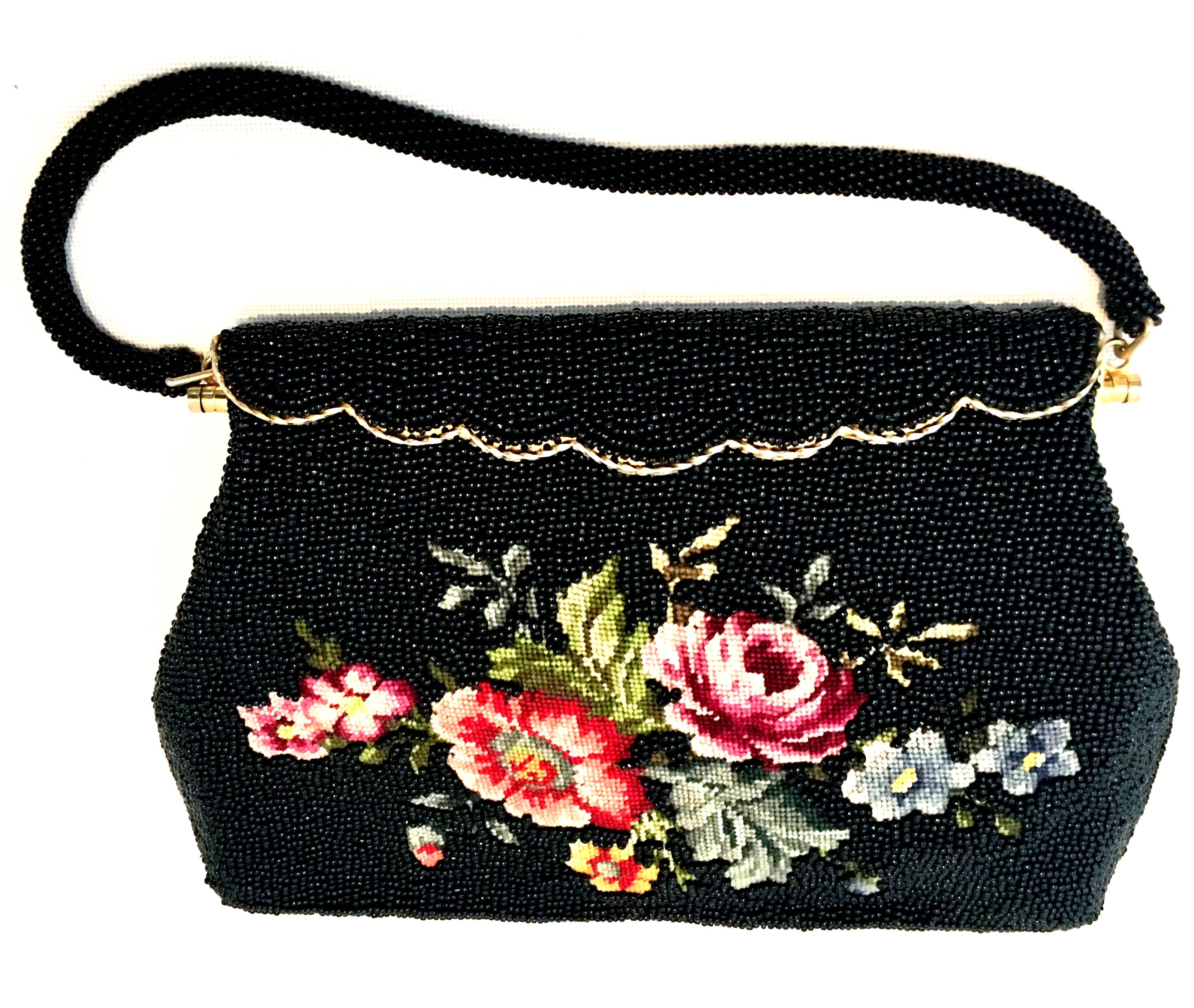 1950'S Hand Beaded & Crewel Embroidered Hong Kong Evening Bag. This pristine and unique piece is executed with jet black art glass beads, and and a crewel embroidered central floral motif. The rope style handle strap is also made of jet black art
