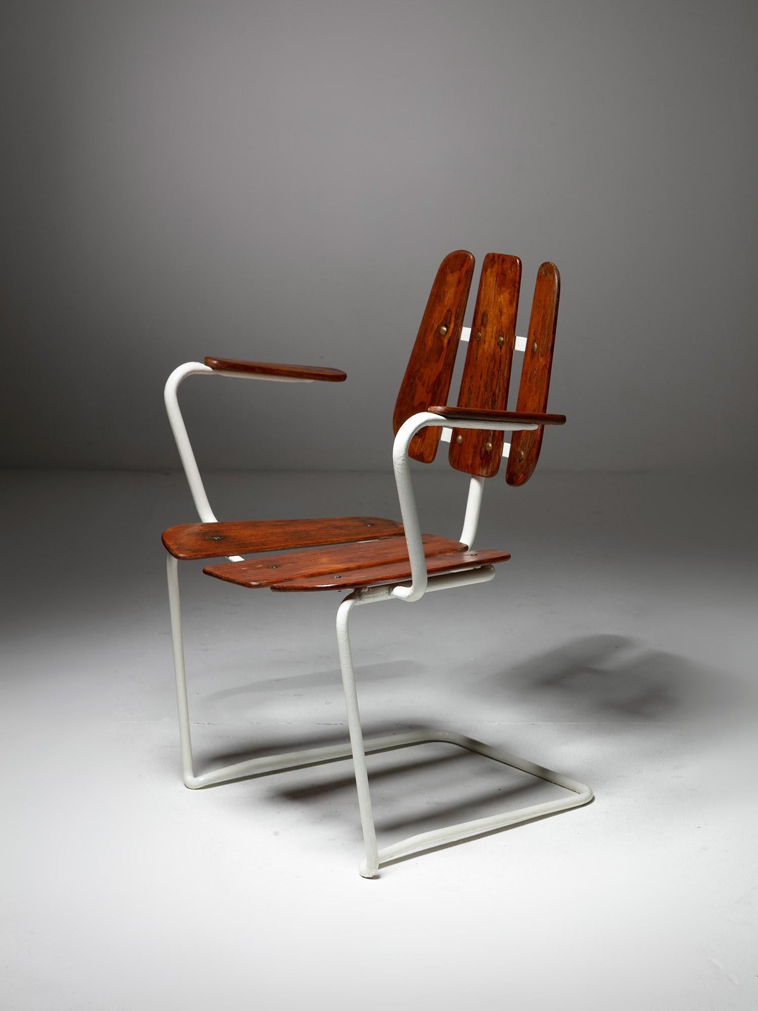 Rare 1950s patio armchair featuring a white metal frame supporting thin organic-shaped wood slabs.