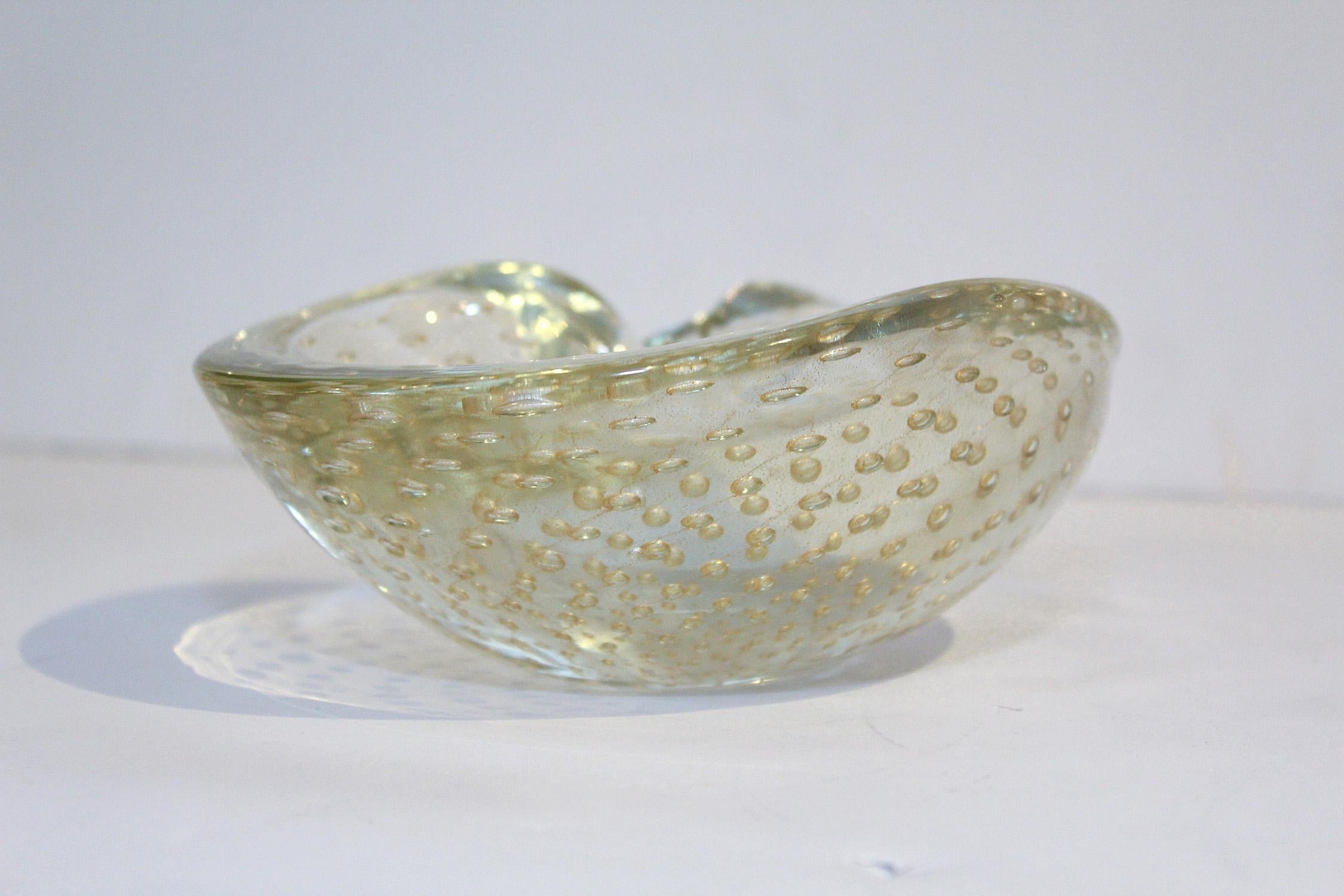 1950s hand blown Seguso clear Murano glass kidney shaped dish with controlled bubble pattern enhanced by gold dust inclusions.