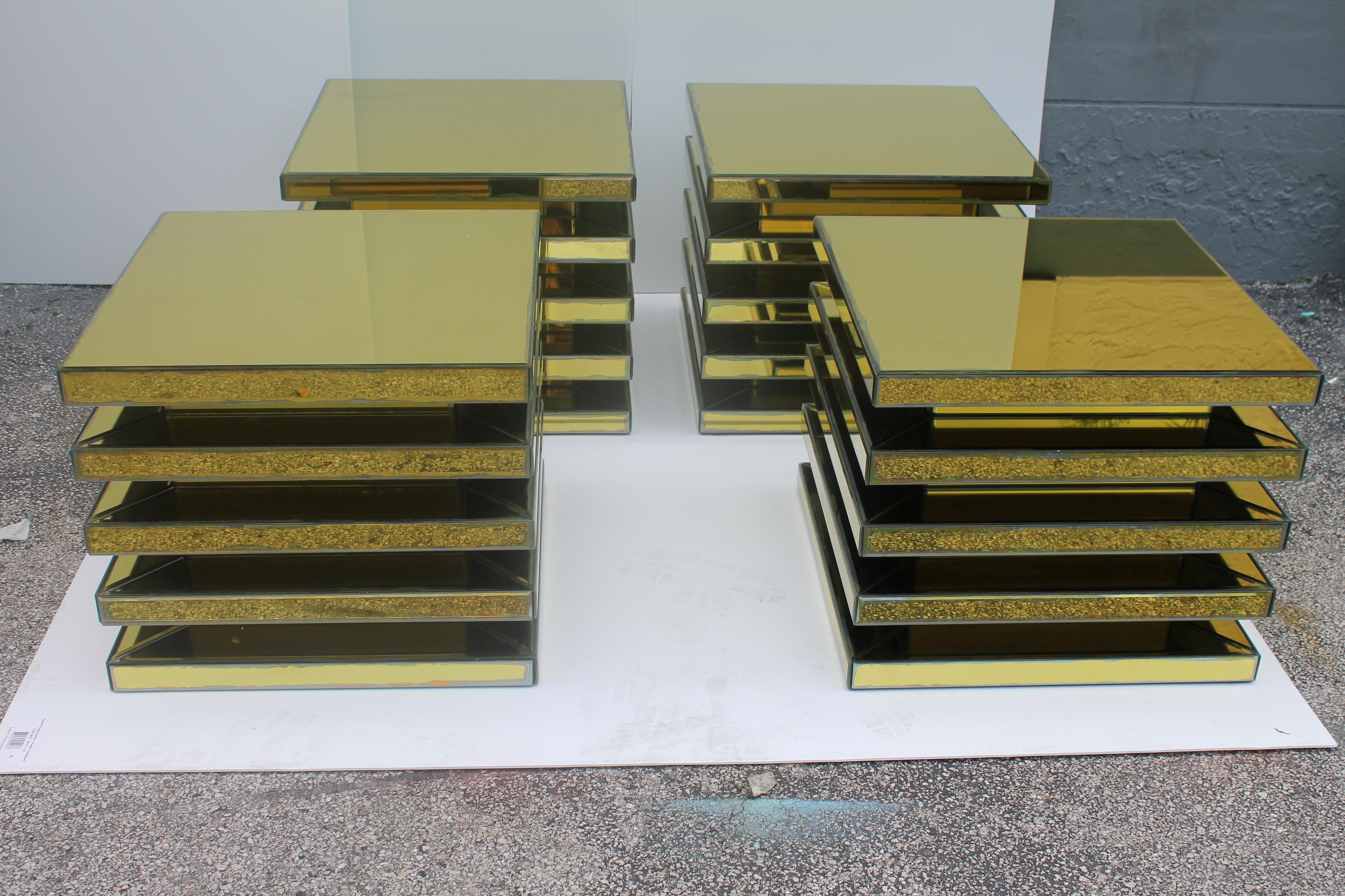 1950's Set of 4 Mid Century Modern Antiqued Gold Mirrored End Tables/ Accent Tables. Matched tables with 5 tiers each. We purchased these tables at a Miami Beach Estate.