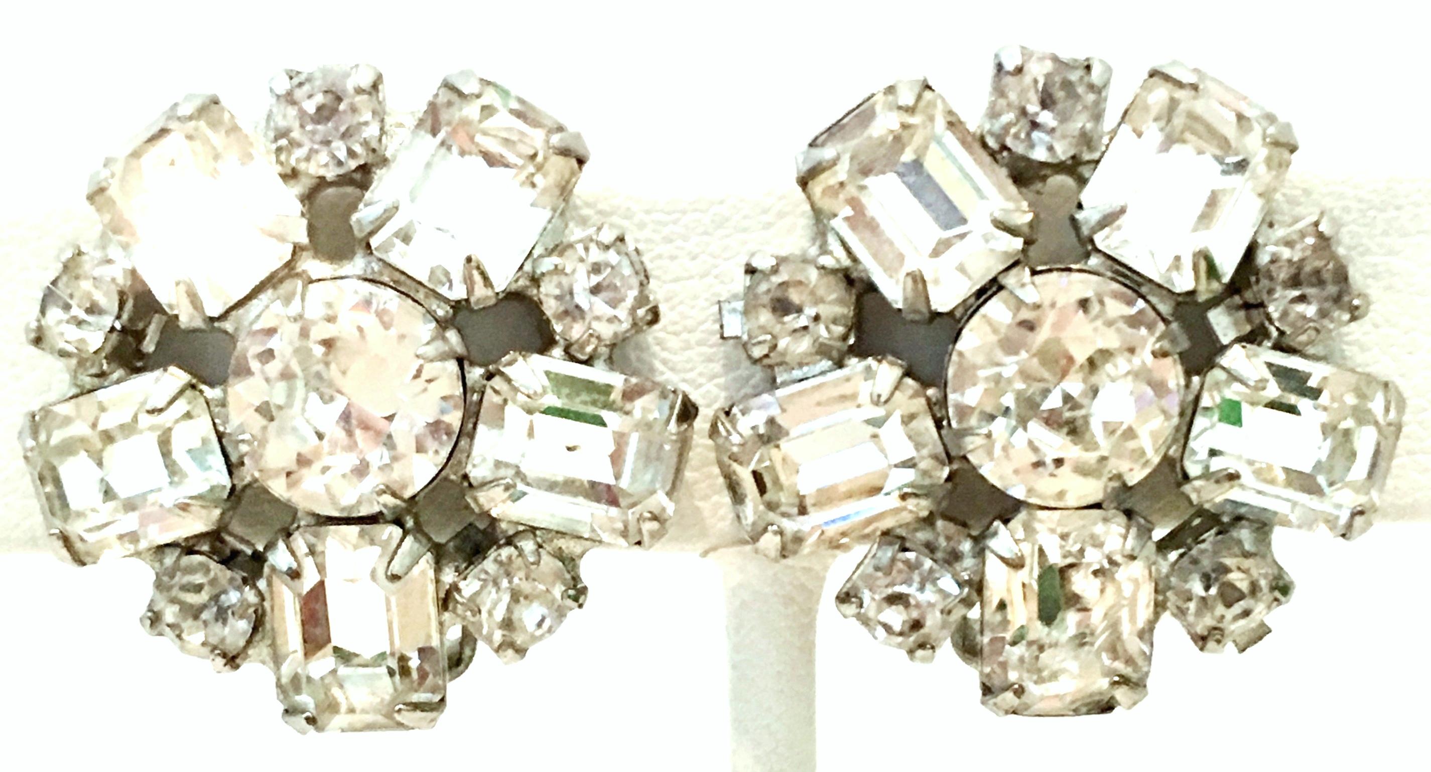 1950'S Silver & Austrian Crystal Clear Rhinestone Abstract Flower Earrings By, Weiss. These brilliant crystal rhinestone clip style earrings are emerald and round cut prong stones set in silver tone metal. One earrings is signed on the back of the