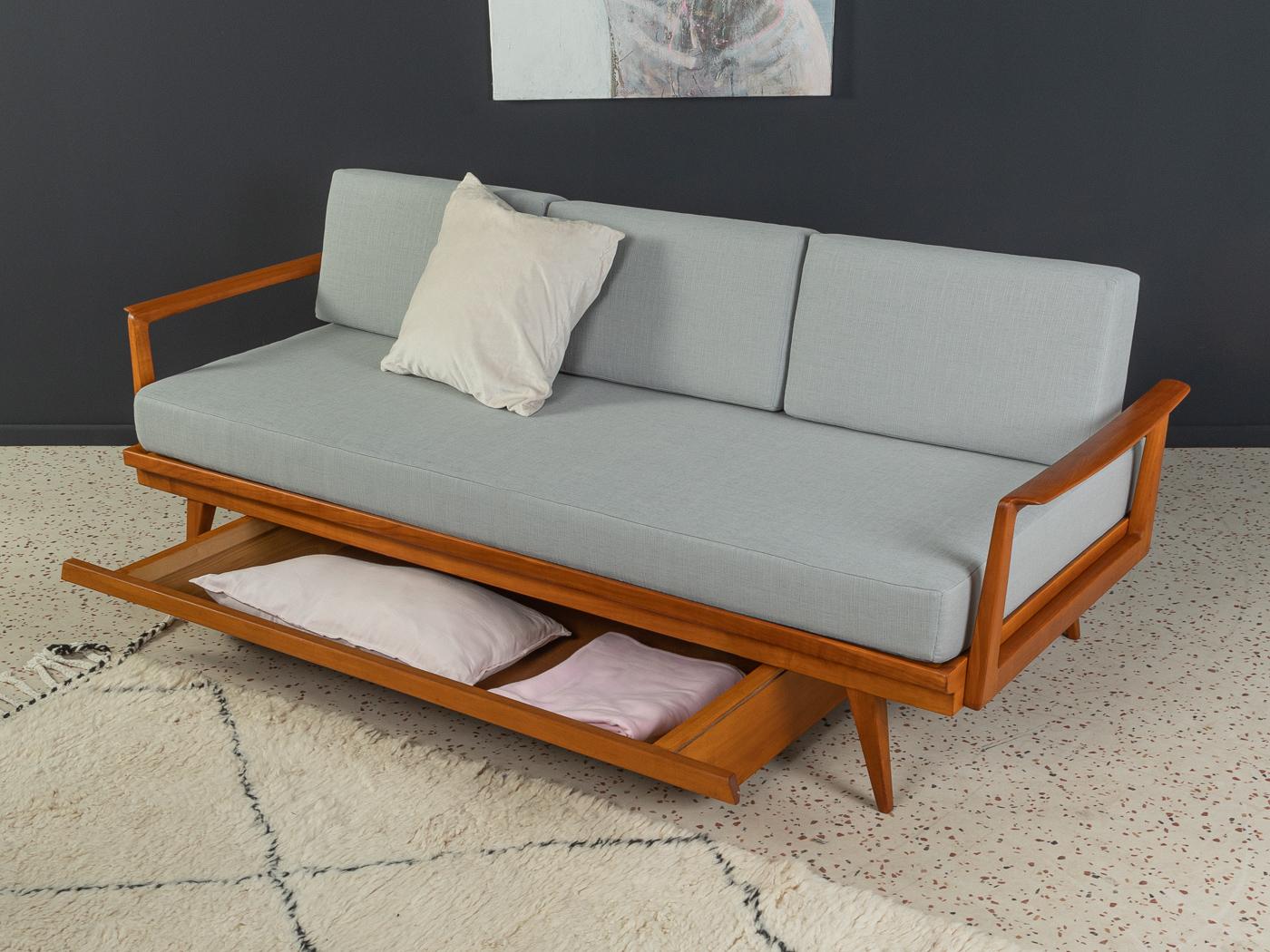 Wonderful sofa from the 1950s, solid frame and bed box in cherry wood stained in teak. The sofa has been reupholstered and covered with a high-quality fabric in light grey.

Quality features:
Accomplished design: perfect proportions
High-quality