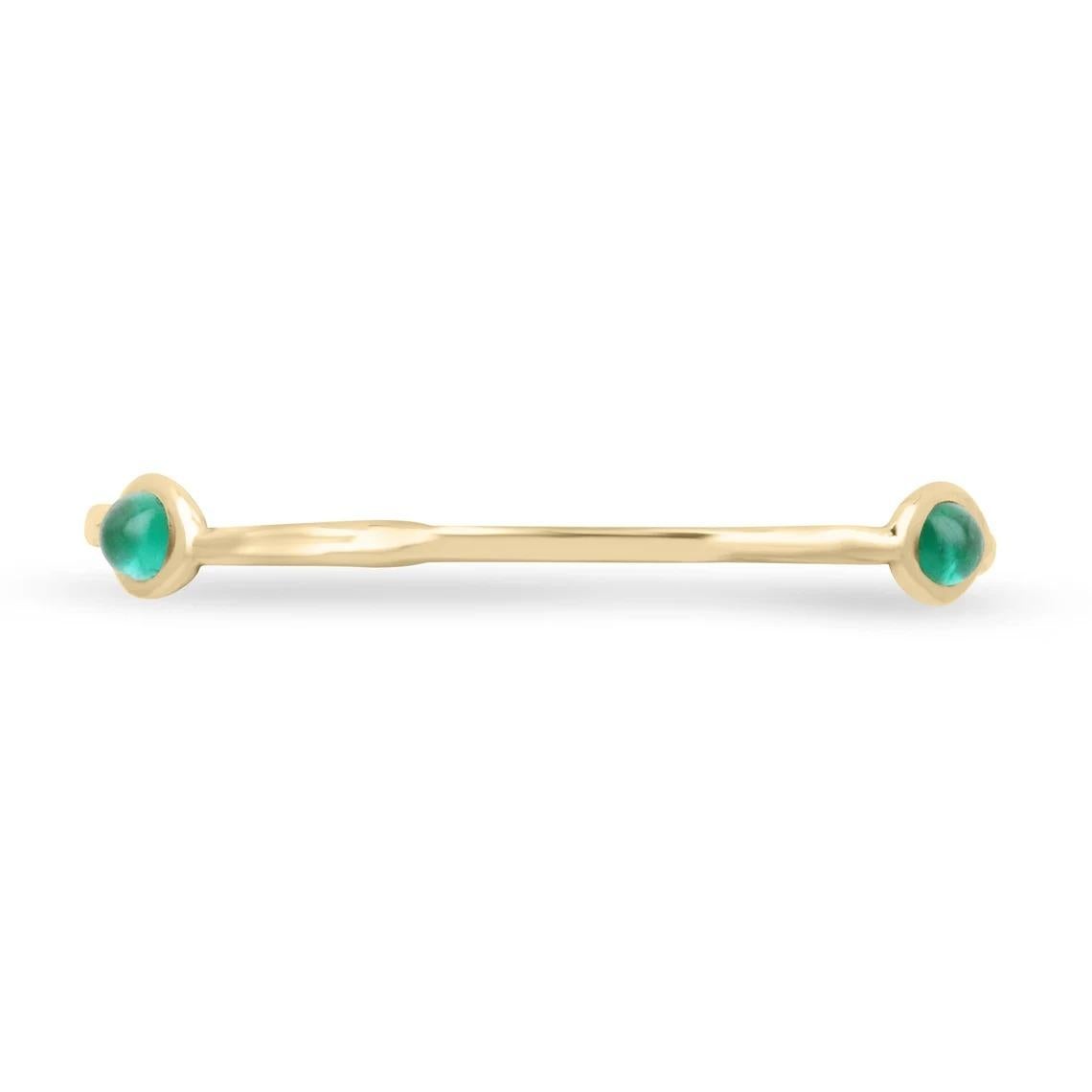 Featured is a stunning high-quality natural emerald cabochon bangle bracelet. This special piece showcases three stunning oval-shaped natural cabochon cut emeralds, spread out evenly. Bezel set within an irregular-shaped gold bangle bracelet.