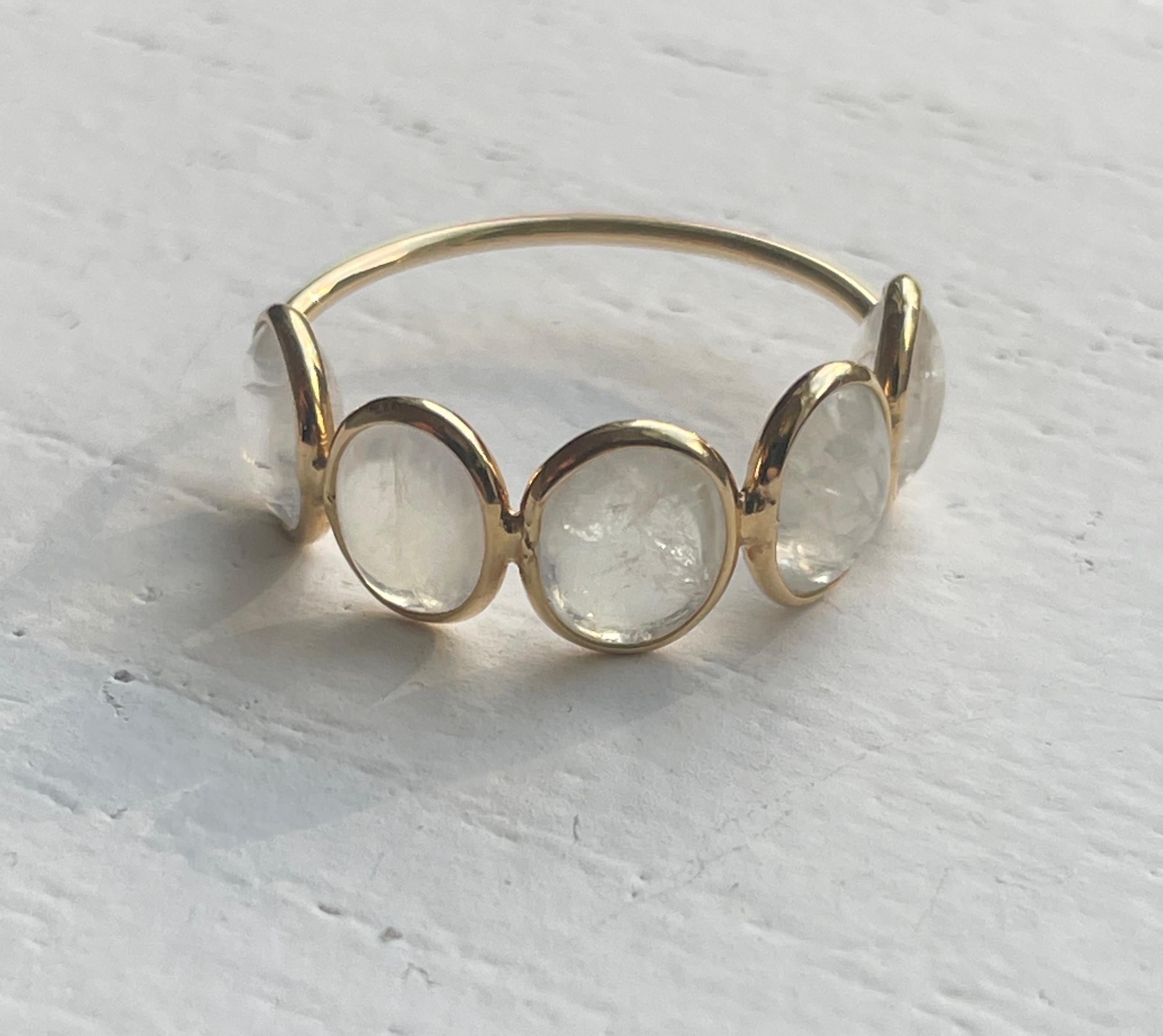 Bezel set in 18K Gold, this cabochon Moonstone showcases maximum sparkle and shine. The ring is comprised of 5 Oval Cabochon stones. The minimal bezel setting allows for the surface of the stone to be exposed creating sparkle and iridescence. As